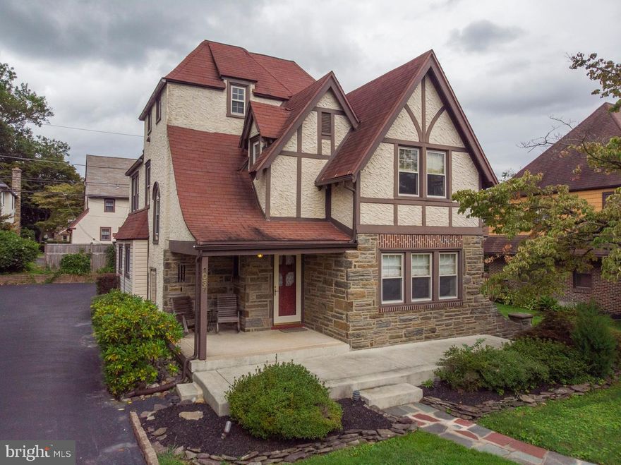 Aronimink  Beauty - Tudor Style  This home is located within walking distance to elementary schools, bus route and local shopping.   A 2.5 story tudor with open front porch, Enter to Cozy Foyer, Living Room with stone fireplace, hardwood floors & crown molding,  Formal Dining Room with hardwood floors, chair rail and crown molding with french doors to outdoor deck and patio.  Full remodeled kitchen with quartz countertops, built-ins and breakfast bar, along with  Refrigerator, Microwave and wall double oven.    2nd fl:  Master Bedroom with updated bathroom,  including stall shower, custom california closets and hardwood floors.   3 additional bedrooms with hardwood floors and fully remodeled and expanded hall bathroom.   3rd fl:   Bonus Room could be used as bedroom, workout room or office and Storage room.   Basement:   Finished Basement with bar area, storage and utility rooms.   Exterior:   Shared Driveway with parking for one car in back, along with 1-car garage.   Large Deck and patio with outdoor waterfall , allowing for a soothing atmosphere while relaxing outdoors.   Gas/Steam Heat, Central Air, 200 AMP Electric service.   This home offers a lifestyle in a beautiful neighborhood - a walker's delight!