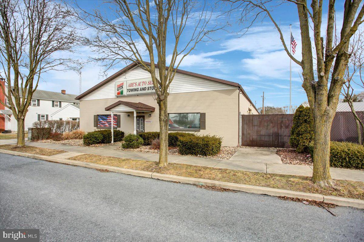 605 Guilford Ave is ready for your business! This great commercial property is conveniently located in the Borough of Chambersburg and close proximity to 1-81, Route 11, and Route 30. This property boasts numerous buildings, a completely fenced-in secure parking area with an automatic electric gate, and numerous vehicle entrances. The main building features a reception area, restrooms, waiting area, private office, large garage workspace, and paint storage room. The ceilings are approx. 12' tall in the garage space, with 3- 10' tall garage doors. The secondary building has a concrete floor, storage area, and 2 garage doors that are 8' tall and another garage door that is 7' tall. There are also tractor-trailer shells that have been converted into covered storage opportunities. There are vehicle lifts and an air compressor currently in the space which can be negotiated with the sale. While previously used as an automotive shop this space can be utilized in other ways! Contact the Boro of Chambersburg for more information and a description of possible uses.