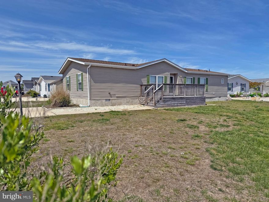 Mariner’s Cove is the place to be if you are a boater, especially since this community has slips for rent, as well as a community boat ramp. Ideal for a vacationing...but this house spacious enough as a year-round residence. This 1,680 sq. ft. doublewide home sits on a premium corner lot. The living room has vaulted ceiling and it adjoins the sunroom, which has a sliding glass door into the enclosed 3-season porch. The eat-in kitchen has space for a dinette set & it has a little breakfast bar. Built-in shelving in the kitchen gives you space to store your cookbooks and small kitchen appliances. There is an electric range with a range hood, a dishwasher, and a fridge. The dining room is just off of the kitchen. Popular split bedroom plan. The main bedroom is en Suite with that bath having a tiled walk-in shower. The other two nicely-sized bedroom share the second full bath, which has a tub shower. Laundry room with a side-by-side washer & dryer. Front and rear decks for outdoor living space. Big shed for your fishing gear. Concrete driveway for 4 vehicles (and Mariner’s Cove does allow you to store your boat in the driveway). Less than 15 miles to the Rehoboth Beach boardwalk. Close to the famous Paradise Grill in Pot-Nets Bayside, and the Mariner’s Cove entrance is across the street from Paradise Pub. And you're just short way from the community pool and clubhouse, which has a fitness center. Golf Carts are allowed. Transferable leasehold interest of $773.38/month (annual lot rent increases are capped by 25 Del. C. Sec. 7050-4054). Homeowner pays electric, water, sewer, & Internet/cable. Two-pet limit. No rentals of any kind are permitted (but family & friends may always visit you). Equity LifeStyle Properties, Inc., the community owner, requires an Application from the Buyer, with acceptance based on the following criteria: 1.)income verification, 2.)credit bureau score, plus evaluation of debt-to-income ratio, and 3.)criminal background check. Financing may be available to qualified borrowers from a few Lenders that specialize in installment/chattel loans for manufactured homes on leased land (flood insurance will be required if you have a loan, otherwise it is optional). Closing costs will include 3.75% real estate transfer tax (collected as DMV Doc Fee) & a Settlement Agent fee. Home is being offered AS IS at this great price with any inspections for "informational purposes" only.