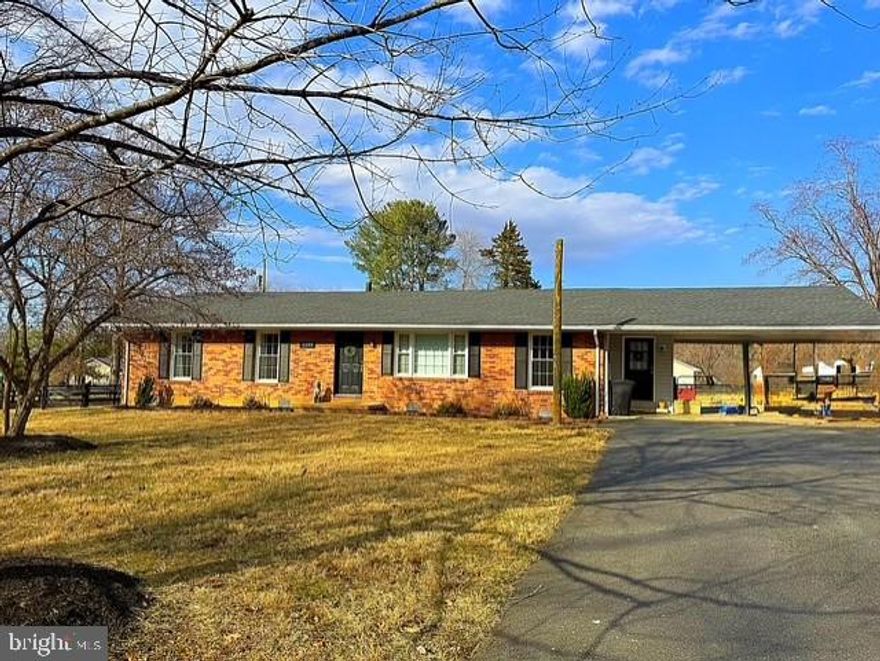 Move-in ready and full of charm! This solidly built brick 3BR/2BA one-level home sits on a generous .82-acre oversized lot in a peaceful neighborhood just a short drive from historic downtown. Enjoy evening walks through the neighborhood and the relaxed feel of country living, all while staying close to town conveniences. Sunlight fills the inviting living room, highlighting beautiful hardwood floors throughout.

A versatile main-level office or sitting room provides the perfect space to work from home or unwind with a good book. The oversized kitchen offers abundant cabinet and counter space with room for casual table-space dining, while a separate formal dining room is ideal for holidays and special gatherings.

Designed for everyday ease, the home features a large mudroom, utility area, and dedicated laundry room. The spacious primary bedroom includes a private full bath, with two additional nicely sized bedrooms nearby. An enclosed sunroom adds year-round enjoyment and extra living space.

Step outside to the large, fully fenced backyard, offering plenty of room to play, garden, or let pets roam safely. Additional highlights include a carport and paved driveway for convenient parking. Major updates include new windows, roof, and HVAC, new drain field installed in 2016, fully renovated bathrooms in 2025, and a brand-new hot water heater (2025). No HOA.

Solid construction, thoughtful updates, and space to enjoy the outdoors—this home truly offers the best of both worlds.