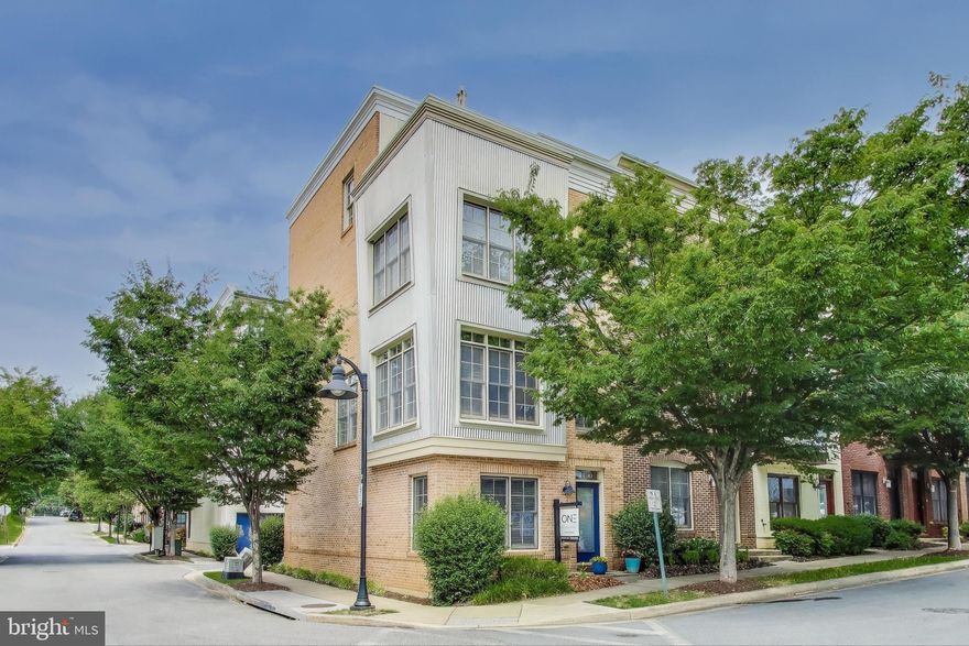 ***This home qualifies for 'The Welcome Home Grant' - up to $10,000 towards closing costs or down payment. Contact listing agent for more information***

Welcome to this stunning 4 level, end-unit townhome located in the vibrant Hyattsville Arts District - a dynamic community offering a unique blend of shops and restaurants and convenient commuter access. This rare 4 bedroom, 3.5 bathroom home features a spacious layout, upscale finishes, and exceptional outdoor living spaces, including a private rooftop deck.

Inside the main level, gleaming hardwood floors guide you through a bright and airy living space. The expansive kitchen is a chef’s dream, boasting an abundance of rich wood cabinetry, granite countertops, stainless steel appliances, and a massive center island with seating - perfect for entertaining. The kitchen flows seamlessly into the dining room and spacious living area, where wall-to-wall windows fill the home with natural light.

Upstairs, beautiful hardwood floors continue into two generously sized bedrooms each with en-suite bathrooms. On the top level, you’ll find a third private bedroom with en-suite bath, plus a versatile bonus space ideal for a home office, lounge, or fitness area with direct access to the private rooftop deck. The entry-level includes a fourth bedroom or office, a convenient half bath, and garage access.

Community amenities include a fitness center, party room, outdoor pool, playground, and a free shuttle to nearby Metro stations. Enjoy unbeatable access to local favorites like Yes! Organic Market, Whole Foods, Busboys and Poets, Vigilante Coffee, Riverdale Park Station, and Bladensburg Waterfront Park. Just minutes from the University of Maryland, Catholic, Gallaudet, and Howard Universities. Commuting is a breeze with easy access to Route 1, East-West Highway, Kenilworth Ave, Queens Chapel Rd, Riverdale MARC Train Station, and the Hyattsville Crossing and West Hyattsville Metro stations.