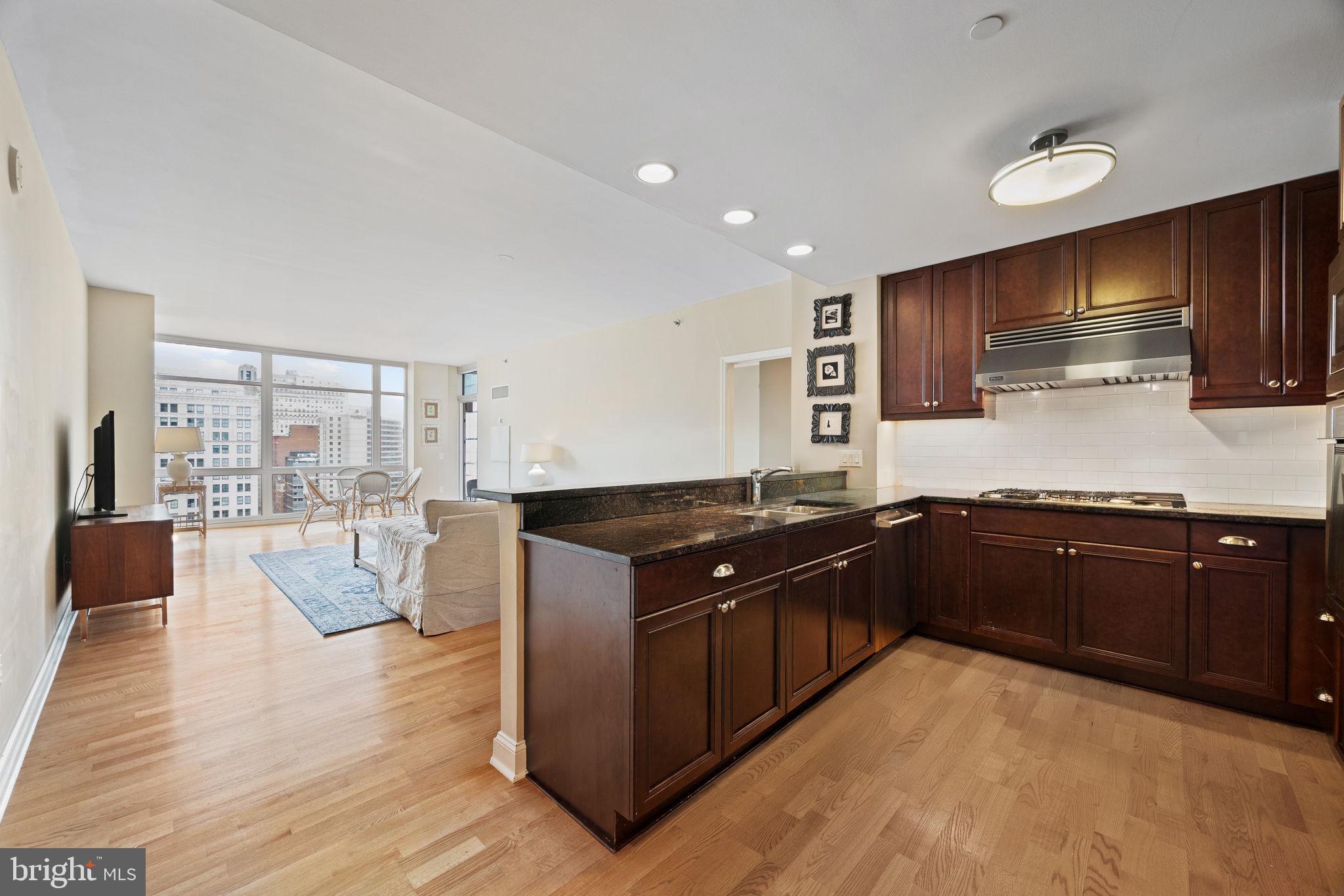 Welcome to the 25th floor of Symphony House, the crown jewel of Philadelphia’s Avenue of the Arts. This 1,405 sq ft 2 bedroom 2 bathroom residence offers a rare combination of space, flexibility, breathtaking 180-degree skyline views—including a bit of both sunrises and sunsets from your private balcony.
The heart of the home is an expansive open-concept living and dining area, framed by floor-to-ceiling windows that flood the space with natural light. The dining area is positioned right on the window line, offering a dramatic backdrop for every meal.
The chef’s kitchen is both functional and elegant, featuring high-end appliances, abundant storage and counter space, and a peninsula with bar seating—perfect for casual dining or entertaining. The seamless flow into the living and dining areas creates an ideal environment for gatherings, large or small.
The layout is thoughtfully designed with split bedrooms for maximum privacy, and a versatile flex space that can serve as a home office, den, or nursery. The primary suite includes a stall shower with frameless glass enclosure, while the hall bathroom offers a full tub.
Symphony House delivers five-star amenities and services, including a 24/7 concierge and doorman, 65’ indoor heated lap pool, steam and sauna, state-of-the-art fitness center, bike share, outdoor terraces, clubroom, library, wine cellar, chef’s catering kitchen, and more.
Situated steps from world-class dining, theaters, shopping, and major transit, this residence offers a dynamic city lifestyle at your doorstep. With a reputation for exceptional stability and prestige, Symphony House remains one of Philadelphia’s most coveted addresses. 1 Car Parking on-site can be rented for an additional $300 per month. Available for move in the 1st week of July