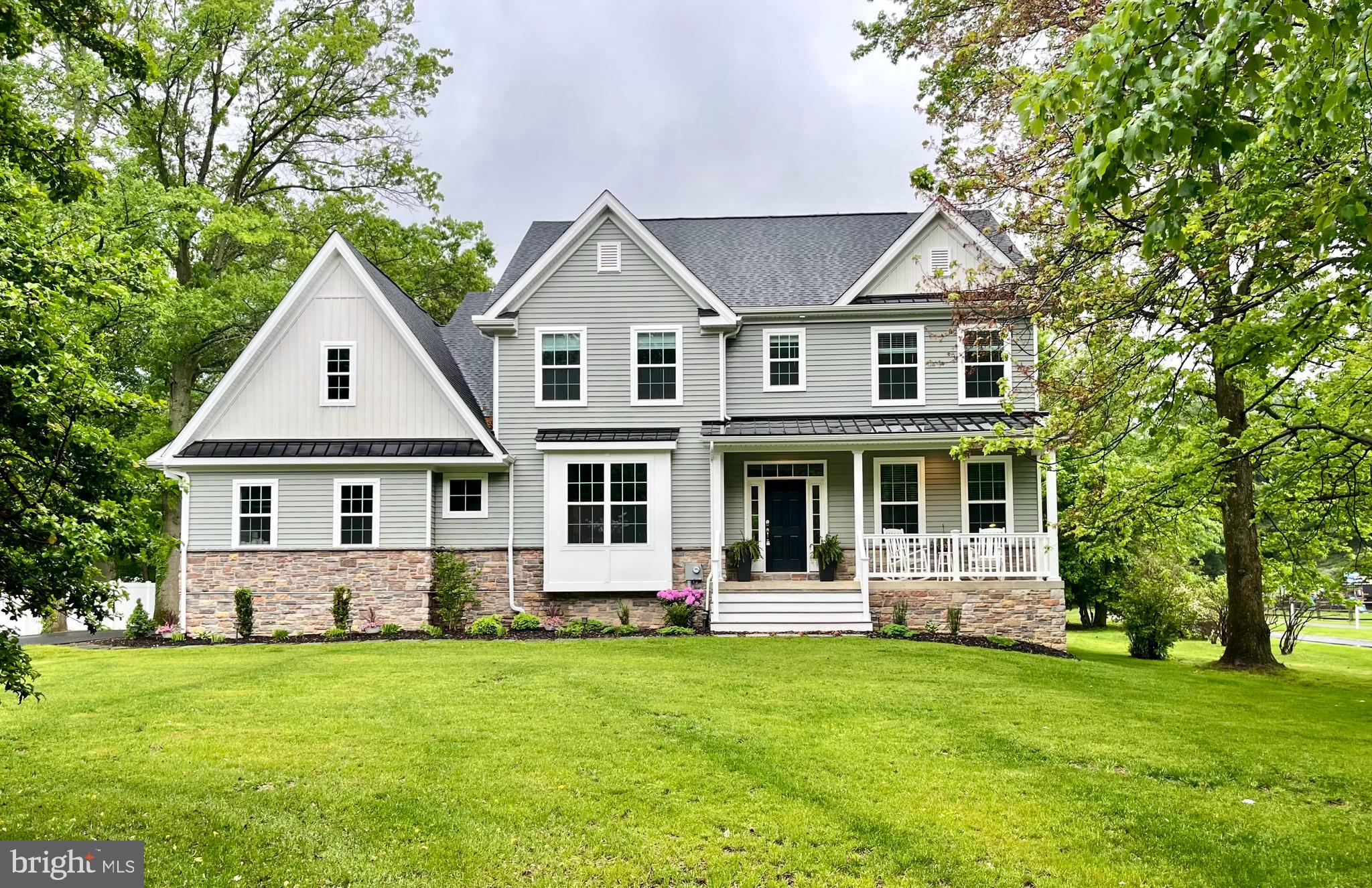Welcome to your dream home! This exquisite, newly built 4-bedroom, 2.5-bathroom residence, completed by Messick Custom Homes, offers the perfect blend of modern luxury and timeless elegance. With approximately 3,300 square feet of finished living space, this home provides ample room for comfort and entertainment, and the 9' high ceilings throughout create a sense of openness and grandeur. Enjoy your morning coffee on the charming front porch, ideal for relaxing and enjoying the serene surroundings. Step inside to find a welcoming home office on one side of the entry foyer and a formal dining room on the other, complemented by engineered hardwood flooring on the first floor that adds warmth and sophistication. The expansive open floor concept seamlessly connects the living spaces, featuring a living area with a cozy gas fireplace featuring a Sony In-House sound system. The heart of the home, the gourmet kitchen, boasts GE Profile stainless steel appliances, a 5-burner gas stove, an oversized kitchen island, and quartz countertops. Enjoy the convenience of shelving slide-outs, a walk-in food pantry, and a butler's pantry with a wine fridge and additional storage. Finishing out the first floor, a spacious mudroom room with a half bathroom lead into the attached two car-garage with carriage-style insulated doors. The second floor hosts a lavish primary suite with two walk-in closets, custom organized built-in shelving, and drawers. The spa-like primary bathroom includes a freestanding soaking tub, double vanities, an oversized tiled shower with a seat and a separate water closet for privacy. Next to the primary, you will find the laundry room, equipped with Samsung front-load washer and dryer, and custom cabinets above the utility sink for storage. Three generously sized bedrooms and a full bath complete the second floor, offering comfort and privacy for family and guests. The basement provides high ceilings and a blank canvas for customization, allowing you to create your dream space. Finishing off the property is the backyard offering a flat, private retreat surrounded by mature growth where you can unwind, entertain, or simply enjoy the beauty of nature. An opportunity awaits to design your own outdoor sanctuary that reflects your personal style and needs. This nearly new construction home combines modern amenities with the charm of mature landscaping. Contact us today to schedule a tour and explore everything this magnificent property has to offer.