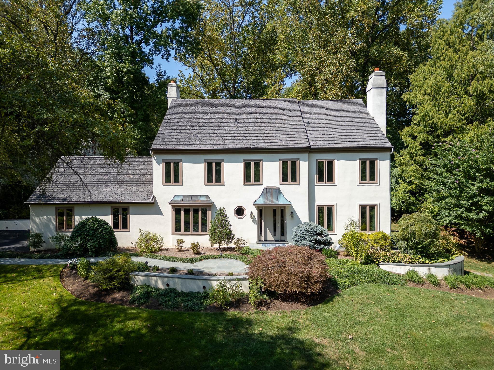 I am excited to bring you a fabulous, updated, spacious home in Round Hill, the neighborhood I call Ravenscliff II, one of the best kept secrets in Wayne, Radnor Township. Welcome to 419 Round Hill Road! This lovely 4-bedroom, 3 full 2 half bath home boasts a generous 5,182 square feet of comfortable living space sitting perfectly on its 0.9 acre fenced yard.
Step inside to be greeted by an unusually large front entry foyer with a coat closet and formal powder room. To the right, the formal living room features large casement windows and a wood-burning fireplace providing warmth and stunning views throughout the seasons. Continue to the traditional dining room perfect special occasion meals and celebrations.
The heart of the home is the thoughtfully designed kitchen, renovated in 2021. This expanded space accommodates a generous cooking area with an oversized granite island and an eat-in area for a large table and chairs. Outstanding features include pristine wood custom cabinetry, stainless steel appliances including a Miele dual fuel range, powerful Thermador extractor fan, Miele dishwasher, KitchenAid warming drawer, LG French door refrigerator, and GE 240V Advantium microwave/halogen oven.
A large picture window with side flanker panes overlooks the lush backyard, The window provides abundant natural light, enhancing the kitchen aesthetics. An open space concept connects the kitchen to the adjacent family room with gas fireplace and to the flagstone patio. How perfect for mingling and keeping the cook engaged!
For those working from home, a private office off the family room offers built-in bookcases and ample space for desks and equipment. The first floor also includes a mudroom with a coat closet, more storage and a doggy shower. In the mudroom there is inside access to the attached oversized two car garage.
The second floor features a beautiful master bedroom suite with a sitting area and updated master bath, complete with a steam shower, double sink vanity and private commode. The master suite also has two ample outfitted walk-in closets. There are two other large 2nd floor bedrooms with double closets which share a stylish bathroom with tub shower combination. The second-floor laundry room is equipped with an LG front load washer and Whirlpool electric dryer. The third floor consists of an expansive fourth bedroom with ensuite full bathroom that is ideal for teenagers or guests; as well as a doored off unfinished storage space.
The finished lower level is truly impressive, featuring a built-in bar with full sized dishwasher, recreation area with a SONY 75-inch flat-screen TV & A/V system, a powder room, a craft room and a second kitchen with Bosch electric oven, gas cooktop, warming drawer, Samsung French door refrigerator. Moreover, there is a temperature controlled wine cellar. The lower-level walks out to the side yard perfect for setting up a table and chairs for an additional outdoor relaxing area.
Cherished by its current owners for over 30 years, this home exudes warmth and positive energy. Nestled in a historically significant neighborhood, it was once part of the grand Ravenscliff Estate, renowned for its majestic mansion and expansive grounds that echo the elegance of the Gilded Age. Although the estate has been subdivided, it has left behind charming, tree-lined streets and well-manicured lawns. The home is within walking distance of Willows Park, a stunning 47.5-acre public park. Nearby is the vibrant town of Wayne with restaurants, shops, the arts, and the wonderful Chanticleer Gardens. Convenient to the I-76, 476-the Blue Route, the Philadelphia International Airport and the Saint Davids train to downtown Philadelphia. Home to the fantastic Radnor Township public schools and highly ranked private schools and a multitude of top notch colleges and universities.
Don't miss the opportunity to make this exceptional home and lifestyle yours. Schedule a viewing today and experience 419 Round Hill!