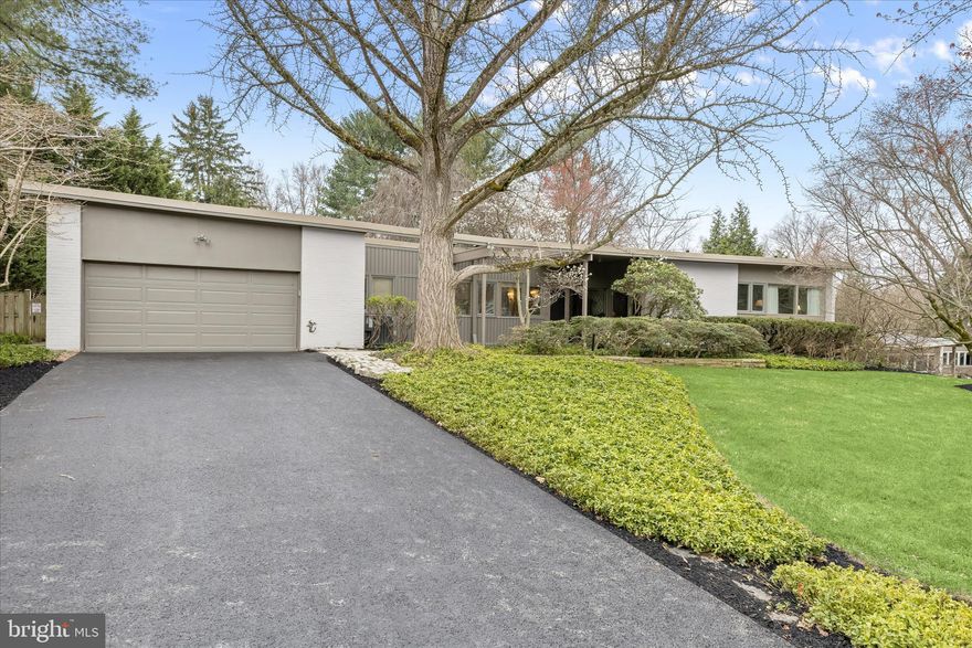 Introducing this remarkable Mid-Century Modern home designed and built by Gordon Sugar in sought-after Stevenson, set on an incredible 0.74 acre lot with lush landscaping and greenery. Offering four bedrooms and three full bathrooms spread across two levels, this home boasts a timeless design that emphasizes functionality with a seamless connection to nature through large windows. Step inside the foyer where slate tile flooring greets you, with a versatile den that provides a flexible space ideal for lounging, an office, or even an extra bedroom. The heart of the home is the impressive open-concept living and dining rooms that are filled with natural light from floor-to-ceiling windows and sliding glass doors that open to the backyard. The soaring vaulted ceiling highlights exposed beams, accented with built-in bookshelves in the living room and a cozy wood-burning fireplace with a brick wall. A spacious and updated eat-in kitchen features a breakfast nook for casual dining, granite counters and backsplash, and high-end stainless steel appliances including a cooktop in the island, JennAir double wall ovens and a SubZero refrigerator/freezer. Completing this side of the home is a laundry room and access to the two-car garage. On the opposite wing of the home, the primary bedroom suite awaits, with two closets and a private ensuite bathroom. Two additional bedrooms and a shared hall bathroom finish the main level. Downstairs, the finished lower level expands the living space with a recreation room that features floor-to-ceiling windows, built-ins, and access outside to a patio. Also located on this level is the fourth bedroom with a walk-in closet, a third full bathroom, a walk-in storage closet, and additional storage space in the utility room. Enjoy spending time outside and taking in the peaceful surroundings in the expansive fenced backyard that has space for everyone’s outdoor activities, with two patios and a deck.