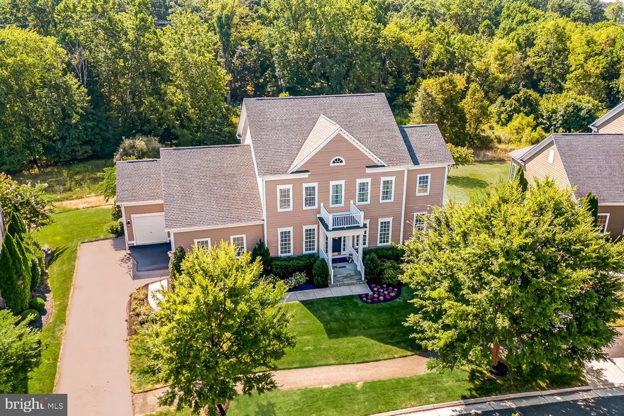 Experience the epitome of luxury living in The Grange at Willowsford! This top-of-the-line Everhardt, a Formal Series model by K Hovnanian, is simply the best in Willowsford. It’s an exceptional estate home that blends elegance with modern comfort. This impressive residence boasts five spacious bedrooms, four full and one-half bathrooms, and encompasses over 5,600 square feet of finished space.
<br><br>
As you step inside, you're welcomed by an inviting foyer flanked by formal living and dining rooms, creating the perfect setting for expanded entertaining. The open-concept floor plan offers upgraded trim and moldings throughout, adding a touch of sophistication. The family room, complete with a stone fireplace and modern fixtures, provides an ideal space for cozy gatherings.
<br><br>
The gourmet kitchen is a culinary haven, meticulously designed to delight any chef. Featuring an abundance of prep, storage, and seating space, the kitchen boasts a generously sized center island illuminated by modern lighting, creating an inviting focal point. The sleek granite countertops and subway tile backsplash exude sophistication, complementing the high-end stainless-steel appliances that grace the culinary space. A gas cooktop, complete with a convenient pot filler, adds both functionality and flair to the kitchen. The sun-filled breakfast room is the perfect space to enjoy morning coffee or casual dining. Work from home in your personal office space, thoughtfully tucked away for privacy. Keep sports equipment, winter gear, and more organized and out of sight with the customized mudroom, accessible from the three-car garage.
<br><br>
Ascending to the upper level, you'll find the epitome of luxury in the opulent primary suite, a lavish space complete with a sitting room, two custom-designed walk-in closets, and a spa-like bathroom featuring a corner soaking tub, separate vanities, and a generously sized walk-in shower. Completing this level are three additional bedrooms, each uniquely designed to provide comfort and character, with a princess suite adding a touch of regal charm. Adding to the practicality of daily living, a conveniently located laundry room ensures daily chores are completed with efficiency and ease.
<br><br>
The fully finished walk-out basement is an entertainer's dream, boasting an exquisite wet bar equipped with ample storage, including two beverage/wine refrigerators and a built-in kegerator. The custom-crafted wet bar seamlessly blends luxury and convenience, providing the perfect ambiance for gatherings big or small with bar seating for 8+ guests. Whether you're enjoying a quiet movie night at home or entertaining friends during football season, this level provides a versatile canvas for your lifestyle. The fifth bedroom and fourth full bathroom, along with a recreation room, game room, and den, complete this level.
<br><br>
Nestled on a meticulously landscaped .33-acre lot, this property provides a tranquil haven with serene views that extend to the neighboring conservation land. The three-car garage, adorned with custom finishes, not only shelters your vehicles but also ensures organized storage. Embrace the outdoors with a screened porch, offering an idyllic spot for relaxation amidst the fresh air. Meanwhile, the deck, complete with stairs cascading down to the yard, establishes a seamless connection between the indoor and outdoor living spaces. Whether unwinding on the porch or hosting gatherings on the deck, this property offers a perfect blend of natural beauty and thoughtful design, inviting you to experience the epitome of your dream home.