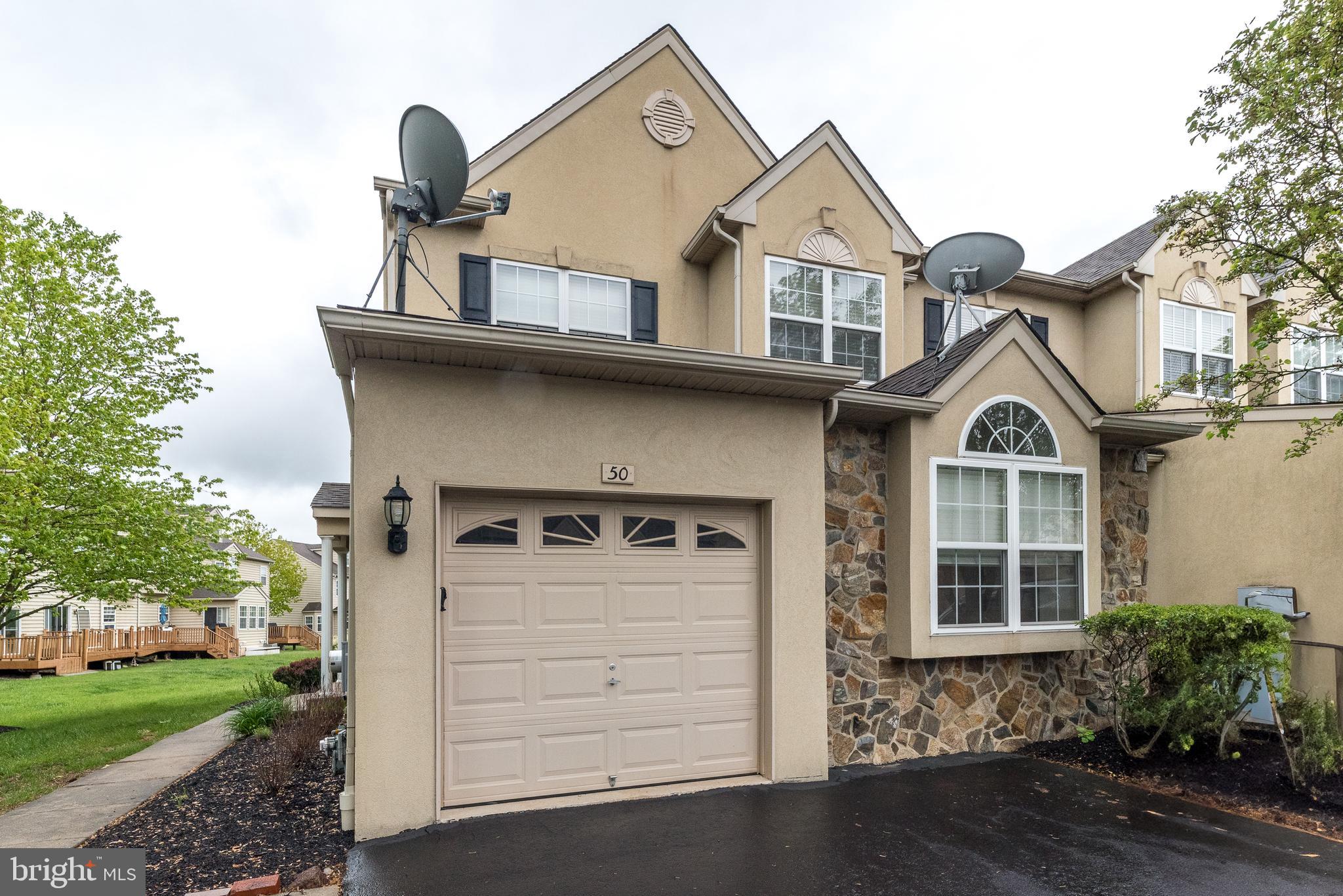 Welcome to this 4-level end unit townhome in The Arbors, located at 50 Arbor Circle, Colmar, PA. This smartly designed residence boasts 2,972 square feet of above-ground living space and offers a total of 3,572 finished square feet, including a fully finished basement. Newly installed neutral carpets on second floor.
Step inside to an expansive living room adorned with hardwood floors, recessed lighting, and a captivating gas fireplace. Adjacent to the living room, you'll find natural light flooding in the windows of the library/office space featuring a vaulted ceiling, deep-silled double windows, and elegant crown molding.
The heart of this home is its fabulous kitchen, which includes a large eat-in area, all tile flooring, and stainless steel appliances with gas cooking. The kitchen is beautifully appointed with Corian countertops, 42" cabinetry, a stylish tile backsplash, and a center island equipped with additional cabinets and electric outlets. A glass slider opens to an all weather deck that offers picturesque views of the backyard and common area. Powder room and closet storage complete this main level.
On the second level, you'll discover the master suite, complete with recessed lighting, a ceiling fan, a walk-in closet, and an additional double closet. The master bathroom features a double vanity, a soaking tub, and a shower stall. Two additional bedrooms on this level share a well-appointed main hall bath, and the laundry area includes a brand new washer and dryer alongside a linen closet.
The third floor is a true highlight, presenting a fully finished loft that serves as a fourth bedroom with a full bath and abundant closet space- it has its own zone for heat/cooling.
The full finished basement is bathed in natural light and includes recessed lighting, crown molding, and all tile floors, offering plenty of closet space and additional storage.
This home also features location, end unit lot and a great layout with a one-car garage with inside access, a two-car driveway, and ample overflow parking. The community's strategic location provides an easy commute to Philadelphia and access to major routes.