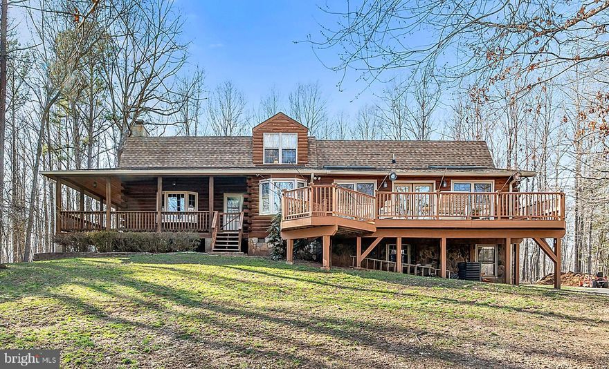 Rustic charm in this comfortable log home with wrap around porch for easy county living.  Two story family room with wood floors, beams and loft area.  Kitchen offers hickory cabinets with island,  2 ovens, pot rack, large pantry with dining area with bay window to watch the wildlife as you dine.  Bar area off kitchen to provide additional dining area.  Large living room with top of the line wood stove and spiral stairs to lower level. Wonderful sun room to relax in and soak up the sun.  Upstairs has Master bedroom with walk in closet, loft area, two additional bedrooms and laundry area.  Remodeled full bath with tiled shower.  Lower level offers a rec room with fireplace(wood or gas), full bath, office area which could be used as a bedroom.  Utility room, storage room and mud room with shower/toilet to clean up after a day outside.  Large deck for entertaining, wrap around porch, shed and patio with hot tub.  Paved circular driveway leads to oversized 2 car garage with storage and room for work benches.  Just 12 minutes to Warrenton for easy commute!