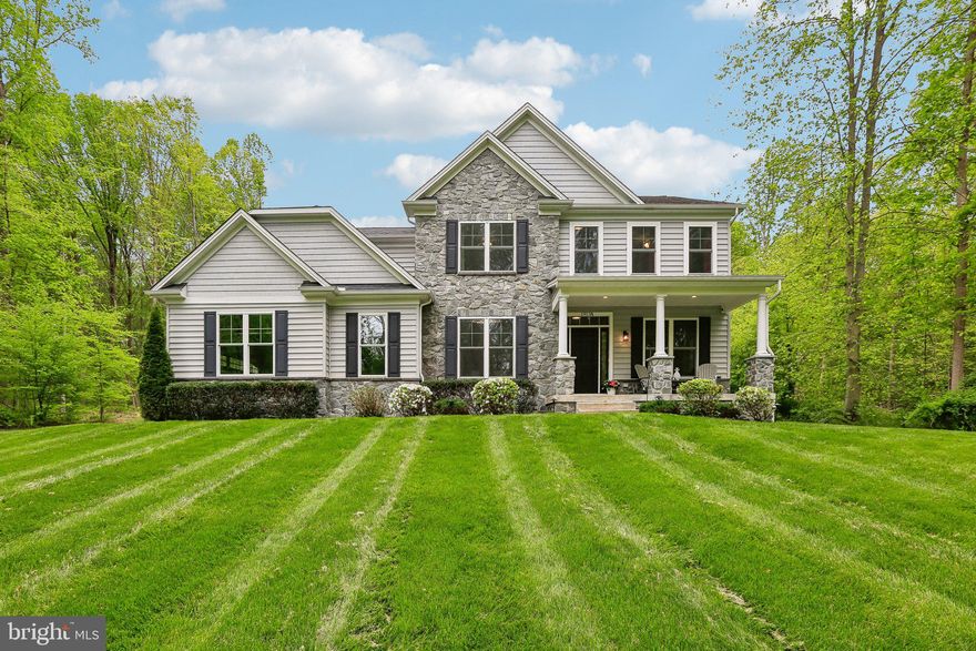 Set well off the road and surrounded by over 7 acres of mature trees, this custom-built Battaglia home offers a level of privacy and calm that’s increasingly hard to find in Bel Air. The approach alone sets the tone—quiet, wooded, and intentionally removed—while a cleared homesite opens the property for both everyday living and outdoor enjoyment.
Inside, the home strikes a balance between refined detail and comfortable living. Sunlight moves easily through the space, highlighting the warmth of the engineered hardwood floors and the craftsmanship found in the moldings, coffered and tray ceilings. Nine-foot ceilings on the main and lower level, generously proportioned hallways create a sense of openness without sacrificing intimacy.
The main level is designed to gather. A welcoming foyer is framed by a dining room made for hosting and a private office tucked behind glass-pane French doors. At the rear of the home, the family room—with its floor-to-ceiling stone gas fireplace—flows effortlessly into the kitchen and breakfast room, creating a space that feels both connected and inviting.
The kitchen is equal parts functional and beautiful, anchored by a large island with a farmhouse sink and surrounded by thoughtful details—double ovens, a five-burner cooktop, and abundant workspace. Just beyond, the breakfast room’s barrel ceiling and natural light create a space you’ll naturally gravitate toward, with direct access to the patio for easy indoor-outdoor living. A well-designed drop zone with built-ins and a walk-in pantry keeps daily life organized without disrupting the home’s aesthetic.
Upstairs, the sense of space continues with an extra-wide hallway leading to the primary suite—a quiet retreat set behind double doors. The tray ceiling adds dimension, while the oversized walk-in closet and spa-like bath elevate the experience. The bath features a large glass-enclosed shower with multiple shower heads and dual vanities connected by a seated vanity, offering both function and a sense of ease.
Three additional bedrooms provide flexibility for family or guests, each with ceiling fans and generous storage, including two with walk-in closets. The upper-level laundry room is thoughtfully placed, adding convenience without compromise.
The lower level expands the home’s livability in a way that feels intentional rather than secondary. With LVP flooring throughout, the space includes a recreation room centered around a sleek electric fireplace and a fully appointed wet bar with granite countertops, 42-inch cabinetry, an ice maker, and beverage refrigerator. French doors leading to the backyard, extend the space outdoors. A flex room, currently used as a gym, sits behind frosted glass doors. An impressive full bath with an oversized shower completes the level.
Outside, the property truly comes into its own. A covered front porch offers a quiet place to start or end the day, while the paver patio with built-in fire pit creates a natural gathering space under the stars. The open yard is ready for everything from casual games to larger gatherings, all framed by the surrounding woods that provide both beauty and privacy.
A side-load two-car garage complements the home’s design and enhances its curb appeal.
This is more than a home—it’s a setting, a retreat, and a lifestyle, thoughtfully created for those who value space, privacy, and quality without compromise.
**** NOT A DRIVEBY **Please do not pull down the driveway without an appointment. Thank you!****