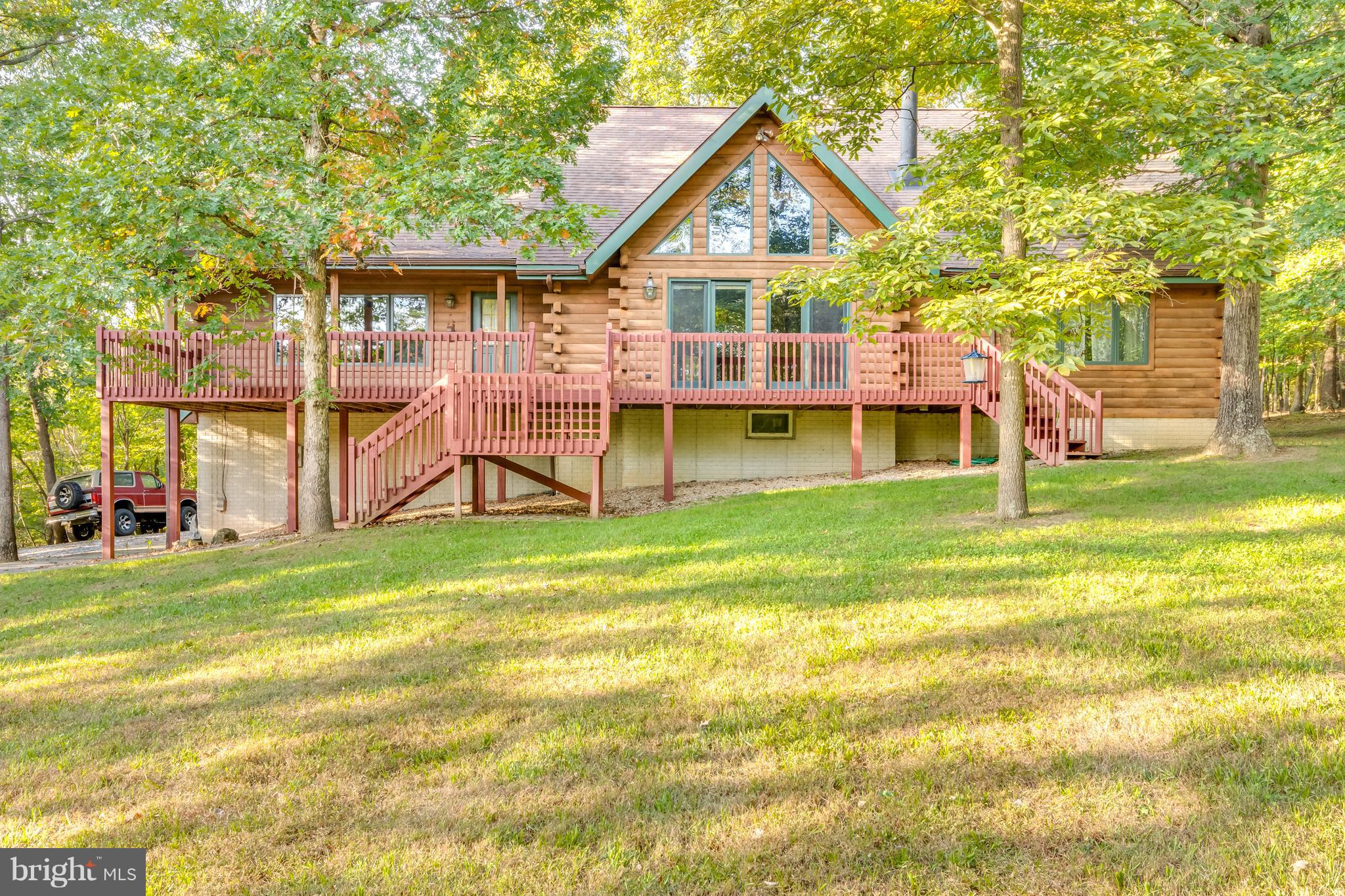 There is a kick out clause on this contract. Schedule to see it today. A grand home with a cozy feel.Custom built log home on 5+ very private acres.New appliances & a huge stone fireplace. Open concept, beautiful wood floors, hickory cabinets in kitchen + lots of windows.Tall cathedral ceilings w/beams &skylights.Big main level master BR & a great finished upstairs loft w lots of windows.Mature trees & sizable deck to enjoy this beautiful property. It's a must see.