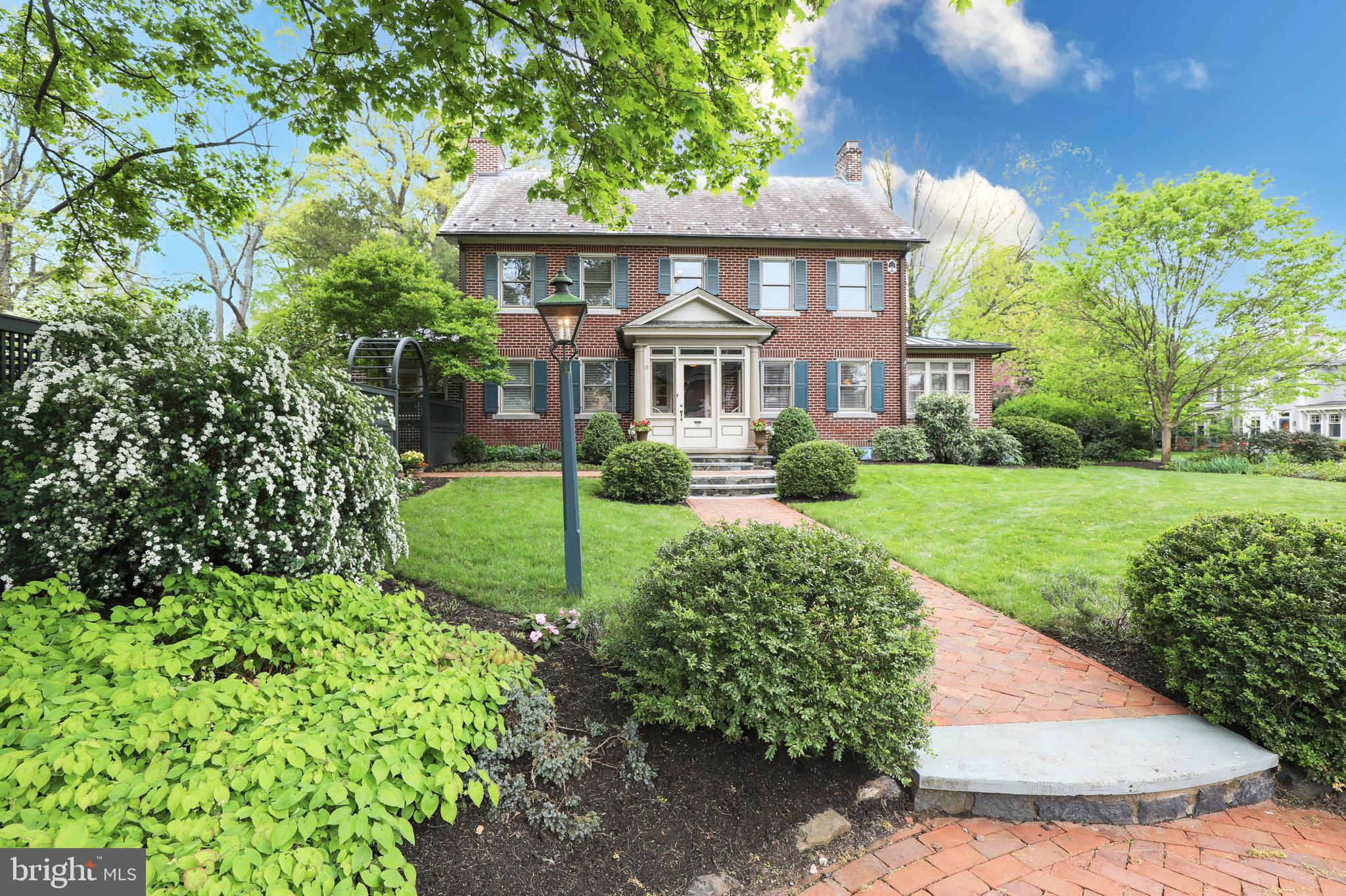 A Classic Doylestown Boro property you don’t want to miss! A true center hall Colonial built in 1929, the home has a charming Oscar Martin feel with a comfortable and flowing floor plan. The home boasts approximately 4100 square feet of living space, 4 bedrooms, 3 and a half baths and many original built-ins and custom millwork.
Upon entering the vestibule, you’ll observe the quiet elegance of the home, the gracious room sizes, and abundance of natural light.
The main floor offers a living room with a stunning wood-burning fireplace depicting the story of the Arkansas Traveler; the last tile installation done by the renowned Henry Mercer. Just off the living room through original French doors is a cozy office, surrounded by windows with built-in bookshelves below and an original Mercer tile mosaic. The dining room is Thanksgiving spacious, with original built-in corner cupboards, chair rails and a quaint French pocket door leading to the family room. The Superior Woodcraft gourmet kitchen features a large center island with stools, abundant cabinetry, granite counters, and a farm sink with large windows overlooking the backyard. Wolf appliances include a 6-burner gas stove, 2 convection ovens (one steam), with warming drawers below. A Miele dishwasher and Subzero refrigerator complete the appliance package. There’s plenty of storage, including a butler's pantry ideally located between the kitchen and living room for ease of entertaining. The family room and eat-in area just off the kitchen are surrounded by windows with built-in bookshelves below. A gas Mercer tile fireplace and coffered ceiling makes the adjoining den/TV area cozy. A back enclosed porch/mud room leads to a fabulous backyard entertaining area and a detached garage. The retro half bath is original to the house. A tucked-away screened porch provides a delightful covered outdoor space to relax and take in the gardens.
The second floor has a primary bedroom showcasing a beautiful built-in bureau, all tile en suite bath with whirlpool tub, shower, two sinks, a dressing area and walk-in closet. A second bedroom has a lovely and versatile sitting room surrounded by windows and built-in bookshelves, which could serve as an office, yoga/exercise room, playroom, or just a place to relax.
A third bedroom is graciously sized and filled with natural light. A lovely reading nook compliments the hallway.
The third floor is a beautiful 4th Bedroom, with skylights, a large walk-in closet and a bath with a tiled shower and a marble floor.
A finished lower level with windows and a door to the backyard includes a den, exercise/game area, a bright laundry room with plenty of built-in cupboards, plus separate storage areas and a shop/utility room.
Outside you’ll find an extension of living space to carry you through most seasons! A blue stone & brick patio offers multiple entertaining and dining spots. An outdoor kitchen, with a direct line gas grill, 2-burner cooktop, small refrigerator and prep/serving area on soapstone counter allows for entertaining in style! The oversized lot affords unparalleled privacy for a Boro home and offers a spacious yard that’s partially fenced, professionally landscaped and includes a two car detached garage. Located within two blocks of the heart of Doylestown Boro, this beauty is just far enough to be out of the hustle and bustle but within walking distance to everything you want in iconic Doylestown…Restaurant Row, County Theater, Michener Art Museum, Court House, Library, award winning Central Bucks schools, parks and shopping. This one-of-a-kind property is well designed, impeccably maintained and available for the first time in over 30 years.
