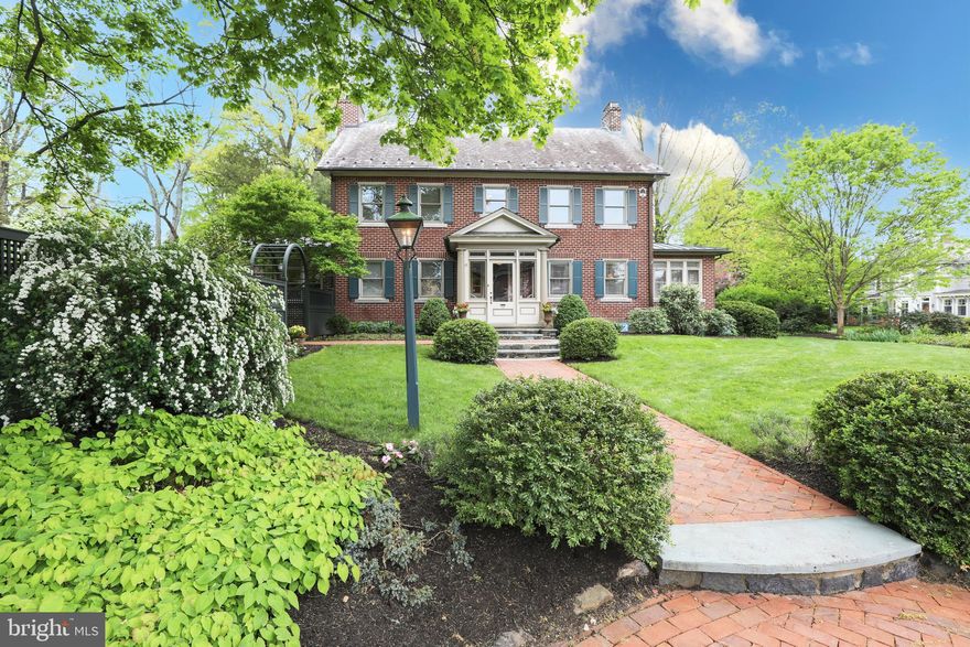 A Classic Doylestown Boro property you don’t want to miss! A true center hall Colonial built in 1929, the home has a charming Oscar Martin feel with a comfortable and flowing floor plan. The home boasts approximately 4100 square feet of living space, 4 bedrooms, 3 and a half baths and many original built-ins and custom millwork.
Upon entering the vestibule, you’ll observe the quiet elegance of the home, the gracious room sizes, and abundance of natural light. 
The main floor offers a living room with a stunning wood-burning fireplace depicting the story of the Arkansas Traveler;  the last tile installation done by the renowned Henry Mercer. Just off the living room through original French doors is a cozy office, surrounded by windows with built-in bookshelves below and an original Mercer tile mosaic.  The dining room is Thanksgiving spacious, with original built-in corner cupboards, chair rails and a quaint French pocket door leading to the family room. The Superior Woodcraft gourmet kitchen features a large center island with stools, abundant cabinetry, granite counters, and a farm sink with large windows overlooking the backyard. Wolf appliances include a 6-burner gas stove, 2 convection ovens (one steam), with warming drawers below.  A Miele dishwasher and Subzero refrigerator complete the appliance package. There’s plenty of storage, including a butler's pantry ideally located between the kitchen and living room for ease of entertaining. The family room and eat-in area just off the kitchen are surrounded by windows with built-in bookshelves below. A gas Mercer tile fireplace and coffered ceiling makes the adjoining den/TV area cozy. A back enclosed porch/mud room leads to a fabulous backyard entertaining area and a detached garage. The retro half bath is original to the house. A tucked-away screened porch provides a delightful covered outdoor space to relax and take in the gardens.
The second floor has a primary bedroom showcasing a beautiful built-in bureau, all tile en suite bath with whirlpool tub, shower, two sinks, a dressing area and walk-in closet.  A second bedroom has a lovely and versatile sitting room surrounded by windows and built-in bookshelves, which could serve as an office, yoga/exercise room, playroom, or just a place to relax. 
A third bedroom is graciously sized and filled with natural light. A lovely reading nook compliments the hallway.
The third floor is a beautiful 4th Bedroom, with skylights, a large walk-in closet and a bath with a tiled shower and a marble floor. 
A finished lower level with windows and a door to the backyard includes a den, exercise/game area, a bright laundry room with plenty of built-in cupboards, plus separate storage areas and a shop/utility room.  
Outside you’ll find an extension of living space to carry you through most seasons!  A blue stone & brick patio offers multiple entertaining and dining spots. An outdoor kitchen, with a direct line gas grill, 2-burner cooktop, small refrigerator and prep/serving area on soapstone counter allows for entertaining in style!  The oversized lot affords unparalleled privacy for a Boro home and offers a spacious yard that’s partially fenced,  professionally landscaped and includes a two car detached garage.  Located within two  blocks of the heart of Doylestown Boro, this beauty is just far enough to be out of the hustle and bustle but within walking distance to everything you want in iconic Doylestown…Restaurant Row, County Theater, Michener Art Museum, Court House, Library, award winning Central Bucks schools, parks and shopping.  This one-of-a-kind property is well designed, impeccably maintained and available for the first time in over 30 years.