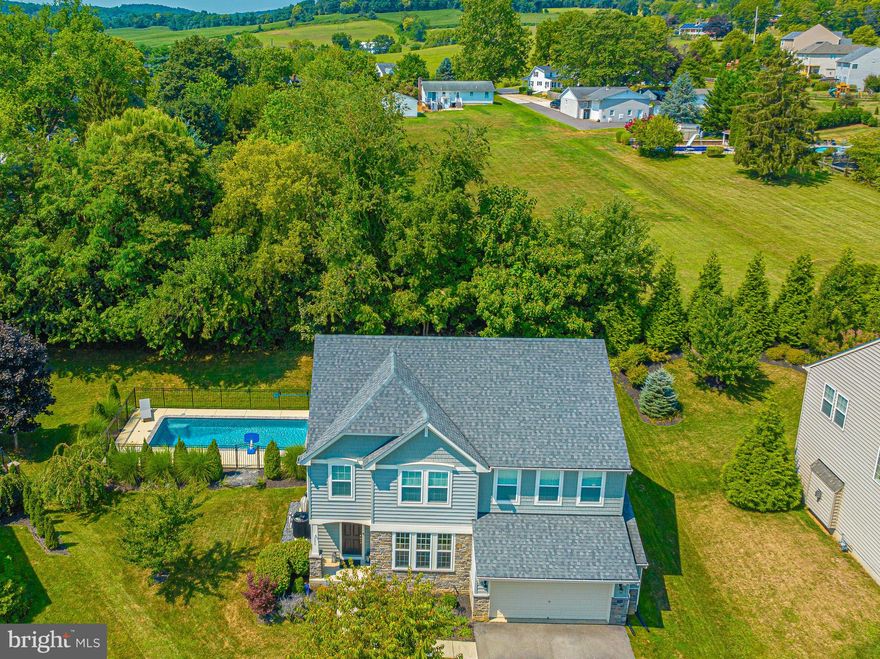 Welcome to your dream home nestled at the end of a peaceful cul-de-sac! This stunning 4-bedroom, 3.5-bathroom single-family home offers the perfect blend of luxury, comfort, and entertainment. As you step inside, you'll be welcomed by an inviting foyer that sets the tone for the elegance that awaits. Gorgeous engineered hardwood flooring flows throughout the main level, leading to the formal dining space, an ideal setting for hosting memorable dinner parties. The heart of this home is the large family room, featuring a cozy gas fireplace that adds warmth and charm to gatherings with loved ones. Imagine starting your day with breakfast in the charming breakfast room, where you can take in picturesque views of the pool and the natural beauty surrounding this property. The chef's kitchen is a culinary enthusiast's dream, boasting a spacious island, ample cabinet space, granite countertops, and top-of-the-line stainless steel appliances. You'll also appreciate the convenience of a large pantry to keep your kitchen organized and well-stocked. Venturing to the second level, you'll discover the primary suite, a serene retreat that includes a luxurious primary bathroom with a double vanity and two generously sized walk-in closets. Three additional bedrooms on this level provide comfort and space for your family or guests. The large basement, with a bathroom rough-in, offers endless possibilities for customization to suit your lifestyle, whether it's creating a home theater, fitness area, or recreation room. Step outside to your private oasis, where you'll find an extended patio, perfect for entertaining friends and family, and a heated saltwater pool for year-round enjoyment. The backyard backs to trees, ensuring privacy and a serene atmosphere. For those who need extra storage space or enjoy working on projects, the extended garage provides ample room for your needs. This exceptional home is not just a property; it's a lifestyle. Don't miss the opportunity to make it yours and experience the perfect blend of luxury, comfort, and entertainment in this tranquil setting. Close to I-70 and 15.  Live your bliss...