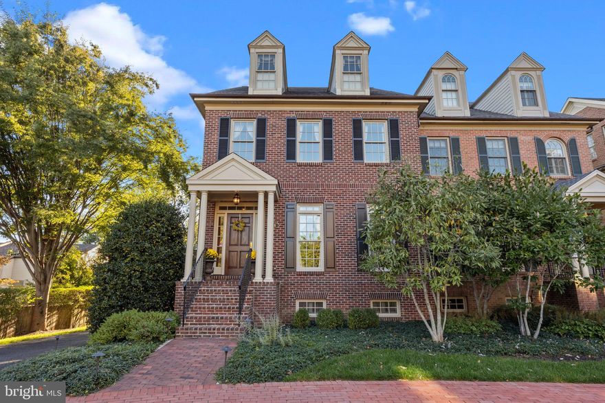 Welcome to this elegant brick townhome situated in a prime location within the highly desirable enclave of Phillips Court, where low-maintenance living meets refined luxury  just steps from shopping, dining  and all the conveniences of town life.  Rich hardwood floors and custom millwork flow throughout the four levels of this beautifully designed home. The gourmet kitchen is a chef’s delight, showcasing custom cabinetry, granite countertops, a center island with prep sink, pendant lighting, and a sunny breakfast area. Thoughtful upgrades include refrigerated drawers, a built-in espresso maker, wine cubby, and spice drawers—perfect for everyday living and entertaining.  The adjoining family room is filled with natural light from oversized transom windows and opens to a spacious raised deck with elegant wrought-iron railings. A gas fireplace with marble surround creates a warm and inviting atmosphere.  The formal living room features a second gas fireplace with marble surround and a classic wood mantle, flanked by custom cabinetry. Floor-to-ceiling windows flood the space with light, while the formal dining room and stylish powder room complete this level.  Upstairs, the primary suite is a true retreat with two walk-in closets and a spa-like en suite bath boasting dual vanities, a jetted tub, and a custom glass-enclosed shower. Two additional bedrooms share a full bath, and there is  a convenient second-floor laundry room as well.   The third level offers a private bedroom, full bath, and a flexible bonus space ideal for a home office, exercise room, or playroom.  The finished lower level expands the living space with a full bath and cedar closet, providing comfort and versatility.   A two-car garage and additional parking complete this exceptional home.