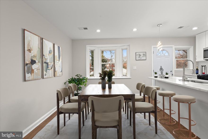 Located in the Woodbourne Heights community of Baltimore City, this interior brick townhome offers a welcoming front porch, a fenced backyard, and the convenience of a private parking pad. A newly renovated interior introduces an open floor plan highlighted by luxury vinyl flooring, recessed lighting, and abundant natural light. The living room flows seamlessly into the dining room, where a bay window overlooks the landscaped grounds and opens to the kitchen.  The kitchen is thoughtfully designed with a center island and breakfast bar, 42” cabinetry with soft-close drawers, a classic subway tile backsplash, stainless steel appliances, and quartz countertops. A main-level powder room completes the living area.  Upstairs, the primary bedroom provides a comfortable retreat with luxury plank flooring, a double-door closet, and private access to the dual-entry hall bath featuring a linen closet and a ceramic tile tub/shower combination. Two additional bedrooms complete the upper level. The fully finished lower level offers exceptional flexibility with space for two possible bedrooms, one with an en-suite bath, or the option for a home office, recreation area, and ample storage.  Enjoy proximity to Chinquapin Run Park, Loyola University Maryland, Notre Dame of Maryland University, and premier shopping, dining, and entertainment at Towson Town Center.