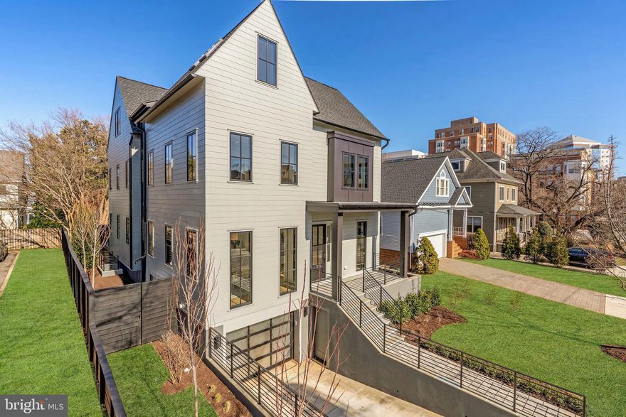 Situated on a quiet Lyon Village street just two blocks from the heart of Clarendon and urban convenience, this stunning transitional custom home blends unique architectural design and extraordinary finishes and details. The ready for occupancy residence was proudly constructed by the renowned N. Arlington builder and architect Griffin Head and their artistry, experience and discerning taste is evident throughout. 
Luxury and comfort abound with over 6400 sq. ft of living space on four levels with 6 bedrooms and 6.5 baths and an elevator accessible to all four levels. The main floor welcomes you with a gracious foyer, office, generous dining room and oversized windows to maximize natural light. Journey into the beautiful custom kitchen with Wynnbrooke solid wood cabinetry, a large center island, Thermador appliances, marble countertops, butler’s pantry with a wine refrigerator and second dishwasher and separate breakfast area. The expansive living room has a gas fireplace flanked by built in shelving and a wall of glass doors that lead to a screened in porch and deck. 
The second level has roomy bedrooms with walk in closets and ensuite baths and the tranquil owner’s retreat has two spacious walk in closets with custom shelving and a serene bath with exquisite finishes. The distinctive top floor boasts an elevated 12 ft. ceiling with rich architectural details and can serve as a media/game room or workspace with the added utility of a second kitchen, enclosed deck with a tree top view and bedroom and bath. The finished walk-out lower level includes a recreation room, spacious gym, mudroom and guest suite. 
Solid oak flooring on all four levels, thoughtful storage, modern audio and technology, efficient systems, an attached oversize garage and a fully fenced yard with custom landscaping complete this magnificent home.  Griffin Head takes great pride in that every one of their North Arlington homes is unique, a reflection of the varied and special lives of it’s occupants.