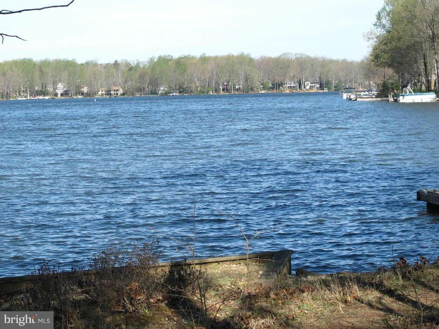 LARGE OVER 18,000 SQ.FT. LOT GENTLY SLOPING DOWN AND TOWARD THE LAKE -  MUST WALK DOWN TOWARD  PROJECTED HOME-SITE TO SEE THE BEAUTIFUL WIDE LAKE VIEWS FROM PROJECTED HOME SITE.  PROPERTY IS CONVENIENTLY LOCATED NEAR CLUB HOUSE, POOL, PRO SHOP, STABLES AND MAIN GATE.  GREAT OPPORTUNITY TO BUILD A NEW HOME ON ONE OF VERY FEW REMAINING BIG LAKE LOTS!  SURVEY IS AVAILABLE.