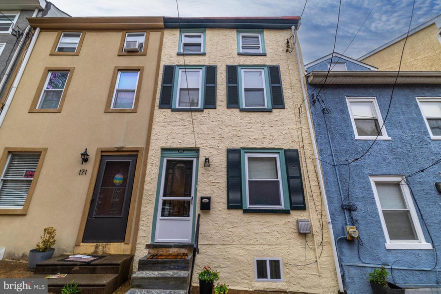 Large 2.5 story 2BR, 1BA townhome with PARKING blending fresh & modern amenities with the charm and craftsmanship of the early 1900's. Beautiful E/I kitchen with S/S appliances including 5-burner GAS stove, Dishwasher, NEW French-Door style Refrigerator, S/S sink, contemporary C/F, and NEW porcelain tile flooring in a lovely neutral light gray tone overlooks a spacious rear deck and garden. Convenient main-floor laundry w/ Full Size Washer and Dryer is tucked neatly away next to the fridge.  Living Room & Dining Room feature handsome walnut stained wood floors, hurricane style sconces flank the curved archway, NEW recessed lighting in LR, and ceiling fan in DR. Proceed up the straight staircase to find a spacious & bright BR with warm wood floor, a decorative F/P, large closet, and smaller "city closet". The XL hall bathroom updates include new contemporary fixtures in tub/shower & sink. The second bedroom on the 3rd floor comprises the entire floor. Wide plank walnut stained wood floors and recessed lighting complete the room. Outdoor garden space, deck and parking in the rear driveway offer an oasis in this urban setting just a short stroll to the commuter rail station Main Street Manayunk cafes, shops, studios and the Canal Path. Come and see this welcoming home today!