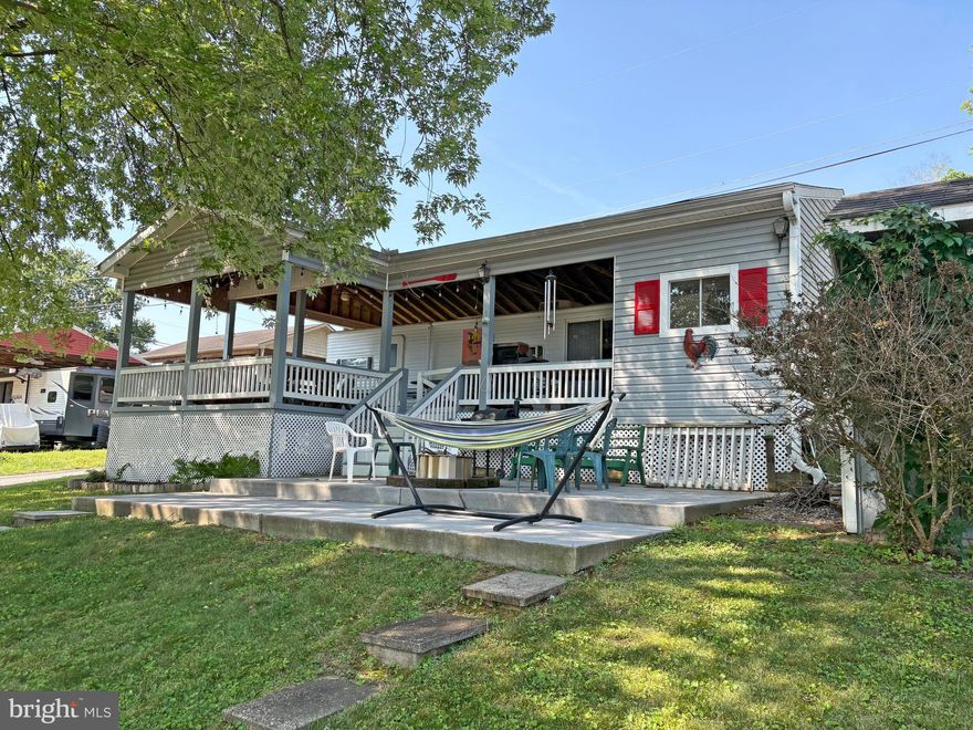 Lot 7-20 in River Bend Park is a turnkey corner RV lot with a partial river view, offering a peaceful and shaded setting with a large shaded deck. This lot includes a 2004 RV, covered deck, concrete patio, fire pit area, outdoor kitchen, shed, golf cart, and dog run—everything you need for easy seasonal living. River Bend Park is a gated community open from April 1 to November 1 each year, with annual dues of $1,775. Dues include electricity, water, trash service, holding tank pump-outs, and access to community amenities such as bath houses, laundry facilities, camp store, tennis and basketball courts, miniature golf, restaurant, rentable pavilions, and more. Lot will not be sold without the RV. All visitors must check in at the guard shack and be accompanied by an agent or owner. There is 1 additional river front lot available for sale across the street - MLS# - WVBE2041960.