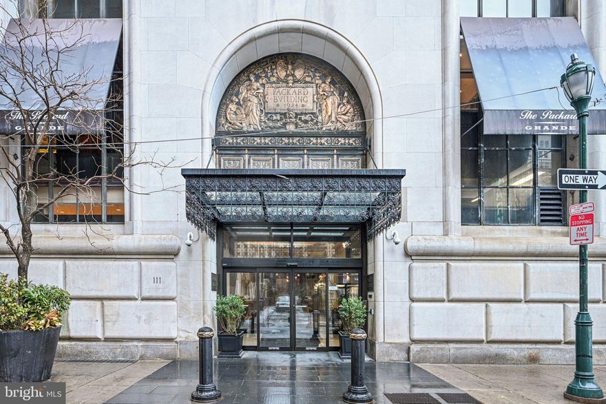 Experience elevated city living in this stunning 20th-floor condo at the historic Packard Grande. This bright and spacious residence features a large open living and dining area highlighted by hardwood floors, 9-foot ceilings, and walls of windows that fill the home with natural light. The upgraded kitchen boasts high-end stainless steel appliances, including an ultra-quiet premium dishwasher and double-door refrigerator, along with soft-close cabinetry and a custom wine rack. The elegant marble bathroom has been updated with a new sink and toilet. Built-in ceiling speakers by Sonos provide seamless sound throughout, while smart home features such as app-controlled light switches and a thermostat add modern convenience. Residents enjoy luxury amenities including 24/7 concierge and doorman service, a state-of-the-art fitness center, conference space, and inviting indoor and outdoor entertainment areas with panoramic city views. Ideally located within a short distance of SEPTA Regional Rail, subway lines, and PATCO stations, as well as Philadelphia City Hall and Love Park. Surrounded by a vibrant dining scene and just minutes from Trader Joe's, this home offers the perfect blend of comfort, convenience, and sophisticated urban living. Mortgage savings may be available for buyers of this listing.