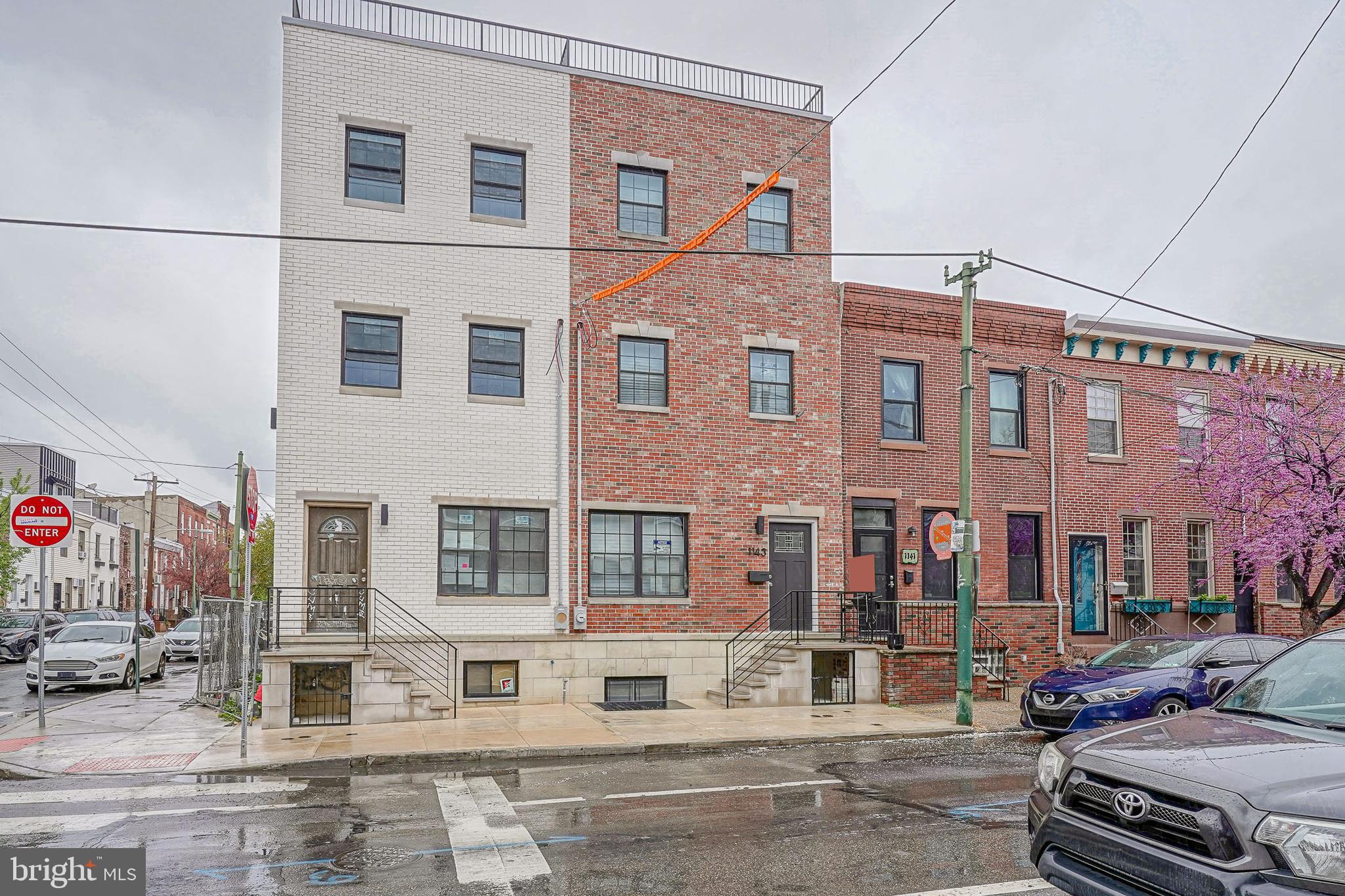 Welcome to 1143 Tasker St – A Truly Exceptional New Construction Home in Passyunk Square. This stunning 3-story residence offers 4 spacious bedrooms, 4.5 luxurious bathrooms, and over 3,000 sqft of thoughtfully designed living space. Featuring 9-foot ceilings on every floor, this home is filled with natural light and elevated by custom, high-end finishes throughout. Step inside to find luxury vinyl floors flowing through every level, anchored by a striking custom oak and wrought iron staircase that connects all three stories. The heart of the home is the chef’s kitchen, showcasing custom oak cabinetry, a waterfall quartz island with pendant lighting, a sleek quartz backsplash, and premium Café appliances, including a wine fridge—perfect for entertaining. The second floor offers two generously sized bedrooms, each with ample closet space and private en-suite bathrooms. On the third floor, you’ll find two additional large bedrooms, including a luxurious primary suite featuring a spacious walk-in closet and a spa-like bathroom complete with a double vanity and quartz countertops. A stylish hallway bathroom serves the additional bedroom on this level. Enjoy rooftop relaxation on the fiberglass roof deck with breathtaking views of the Philadelphia skyline. The fully finished basement provides additional versatile living space—ideal for a home office, gym, or media room. Located just steps from the vibrant Passyunk Avenue strip, you’re surrounded by Philly’s top restaurants, bars, boutique shops, and all the energy of this beloved neighborhood. This home truly has it all—style, space, luxury, and location! Schedule your tour today!
Lender paid 1-0 Buy-Down with financing through Movement Mortgage, reach out for further information!
