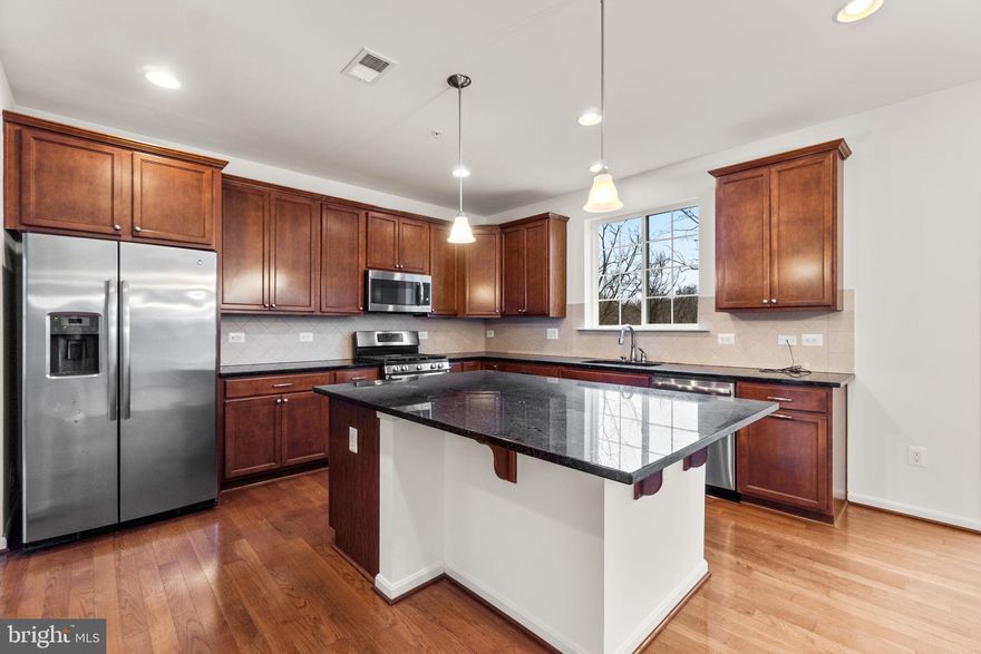 Practically new, beautifully sited colonial in sought-after New Market, just minutes from all that Lake Linganore has to offer without the steep HOA fees or traffic in and out! This house is HUGE and offers plenty of room to spread out both inside and out with more than 3700 finished square feet. This 6-bedroom, 3 full + 1 half bath home features a finished lower level, 2-car garage, and a setting that backs to woods for added privacy.

The main level showcases hardwood floors, 9-foot ceilings, and an open, functional layout including a two story foyer, living room, dining room, kitchen, and breakfast area. The kitchen offers 42” maple cabinets, granite countertops, a large center island, custom backsplash, double oven with 5-burner gas cooking, and a walk-in pantry. A bright breakfast room opens to the trex deck with steps leading to the yard, perfect for entertaining or enjoying the peaceful surroundings, and leads to the huge 1st floor family room too!

Upstairs, the primary suite features a tray ceiling, huge walk-in closet, and a spacious bath with double sinks, a large tiled shower, and ample storage. Additional bedrooms are generously sized, including one with a walk-in closet, and the upper-level laundry adds everyday convenience.

The finished lower level offers exceptional flexibility with a recreation room, home gym and 5th bedroom, full bath with tub/shower, storage with built-in racks, recessed lighting, and walk-out access to the patio.

Freshly painted and brand new carpet too! Move in today!

A rare opportunity for space, privacy, and comfort — all just minutes from New Market amenities.