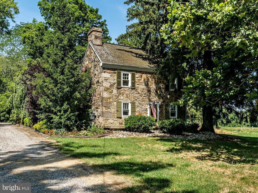 Coventry Forge Farm is a quintessentially historic Chester County country estate, replete with an 18th century stone farmhouse, a fully updated cottage, a studio along the meandering and trout filled French Creek, a 9-stall barn and 23.4 acres of pastures and open space to enjoy. Surrounded on three sides by the 535 acre Warwick County Park and in an area of numerous deed restricted properties, this farm is situated in a highly protected area. The property is of extreme historic significance. In 1717, Samuel Nutt built his home and the Coventry Forge on this property. This iron works was the first constructed in Chester County and only the second in Pennsylvania. Later, Mordecai Lincoln, the great-great grandfather of Abraham Lincoln, became a part owner in the business. Additionally, the works got the attention of such notables as Benjamin Franklin and led to the development of other iron works in this area of Chester County. The antique stone farmhouse is truly special and features deep windowsills and original flooring. You will love the original walk-in fireplace, still located in the Kitchen. The home also has its original root cellar located near one of the garages.  Across the driveway from the stone home is The Cottage, fully updated and complete with interior stone walls, two bedrooms, Kitchen and bathroom – a perfect location for guests or in-laws. Off the driveway’s circle is a flagstone walkway that leads to The Studio. Built by the current owners for large scale entertaining, its Great Room has a large glass window providing tranquil views of the meandering French Creek and the farm’s woodlands, kitchen, and bathroom. Relax while listening to the soothing sound of the creek’s waterfalls from The Studio’s large patio. For the equestrian, the farm also has a well built, nine stall barn with a tack/feed room and plenty of loft storage for hay and bedding. There is easy access to several pastures from the barn and equestrians will love the many trail riding opportunities directly from the farm, including the Horseshoe Trail just up the road. Rounding out the farm’s improvements are two garages capable of housing a total of 4+ vehicles. This wonderful property is within easy walking distance of both the Horseshoe Trail and the French Creek Elementary School in sought after Owen J. Roberts School District. The farm is also convenient to the Routes 23 and 100 corridors. Rarely does a property of such historic significance, coupled with numerous additional improvements, come on the market in such a highly protected location.