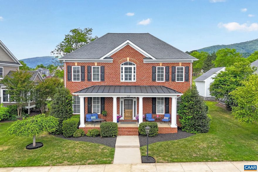 Stately and well maintained Old Trail home with unobstructed pastoral and Blue Ridge Mountain views! This builder's-own 5 bedroom, 4.5 bath home features 9' ceilings, hickory hardwood floors, 2 family rooms, mudroom with built-ins and closet, home office, in-ceiling Sonos sound, screened porch, patio with firepit, rear alley and so much more! White and bright chef's kitchen with commercial gas range/vent, wall oven/microwave, quartz counters, tile backsplash and eating island opens to the large family room with coffered ceiling and indoor/outdoor gas fireplace. The perfect spot for family togetherness and entertaining! Large primary bedroom with walk-in closet, tiled primary bath with dual sink vanity and large shower. Additional second level ensuite bedroom with bonus room. Basement level is walk out/up with windows, family room, additional ensuite bedroom, adorable below-stair play area and lots of storage. The welcoming front porch, rear screen porch with fireplace and patio with gas starting wood firepit are wonderfully relaxing outdoor spaces. The oversized garage rear faces the back alley and built in basketball hoop. Nicely landscaped yard and convenient Old Trail/Crozet location make this a wonderful Old Trail offering!,Quartz Counter,White Cabinets,Wood Cabinets,Exterior Fireplace,Fireplace in Family Room