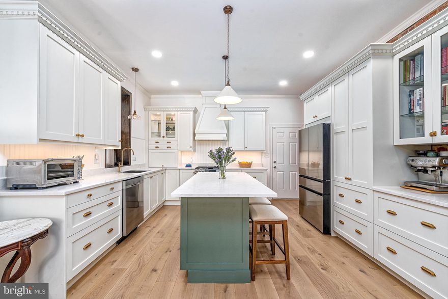 This is one of those homes that quietly overdelivers.

From the moment you step inside, the scale and light feel unexpected in the best way. The main level unfolds as a wide, open living and dining space with warm wood floors, exposed brick, and sightlines that pull you straight through to the heart of the home. A beautifully renovated kitchen anchors the space and is designed for real use and real gathering. Crisp cabinetry, generous counter space, and a large island make everyday living feel effortless, while thoughtful storage keeps the space clean and functional.

Upstairs, the home continues to impress with a true primary suite that is rarely found at this scale. It offers room to breathe, unwind, and truly settle in. Additional bedrooms are well proportioned and flexible, easily accommodating guests, work from home needs, or creative space. The layout across the upper levels feels intentional and balanced, with separation where you want it and connection where it matters.

The upper floors add another layer of versatility with a private office, additional bedroom space, and a light filled loft space that feels tucked away from the rest of the home. Whether used as a media lounge, studio, or quiet retreat, it is the kind of space that adapts as life does.

What truly sets this home apart is how complete it feels. There are multiple living zones, abundant storage, thoughtfully updated baths, and natural light on every level. On the main level, the current storage area was originally designed as a garage and offers future flexibility for a buyer who may wish to convert it back. It functions beautifully as storage today, while preserving long term optionality.

Parking is also available, with the option to secure an assigned space in a nearby lot just half a block away.

Set on a vibrant city block with immediate access to Johns Hopkins Medical Campus, neighborhood favorites, waterfront walks, and the energy that makes this part of the city so special, this home offers the rare combination of scale, character, and livability without compromise.

It is not just move in ready. It is ready to live well.