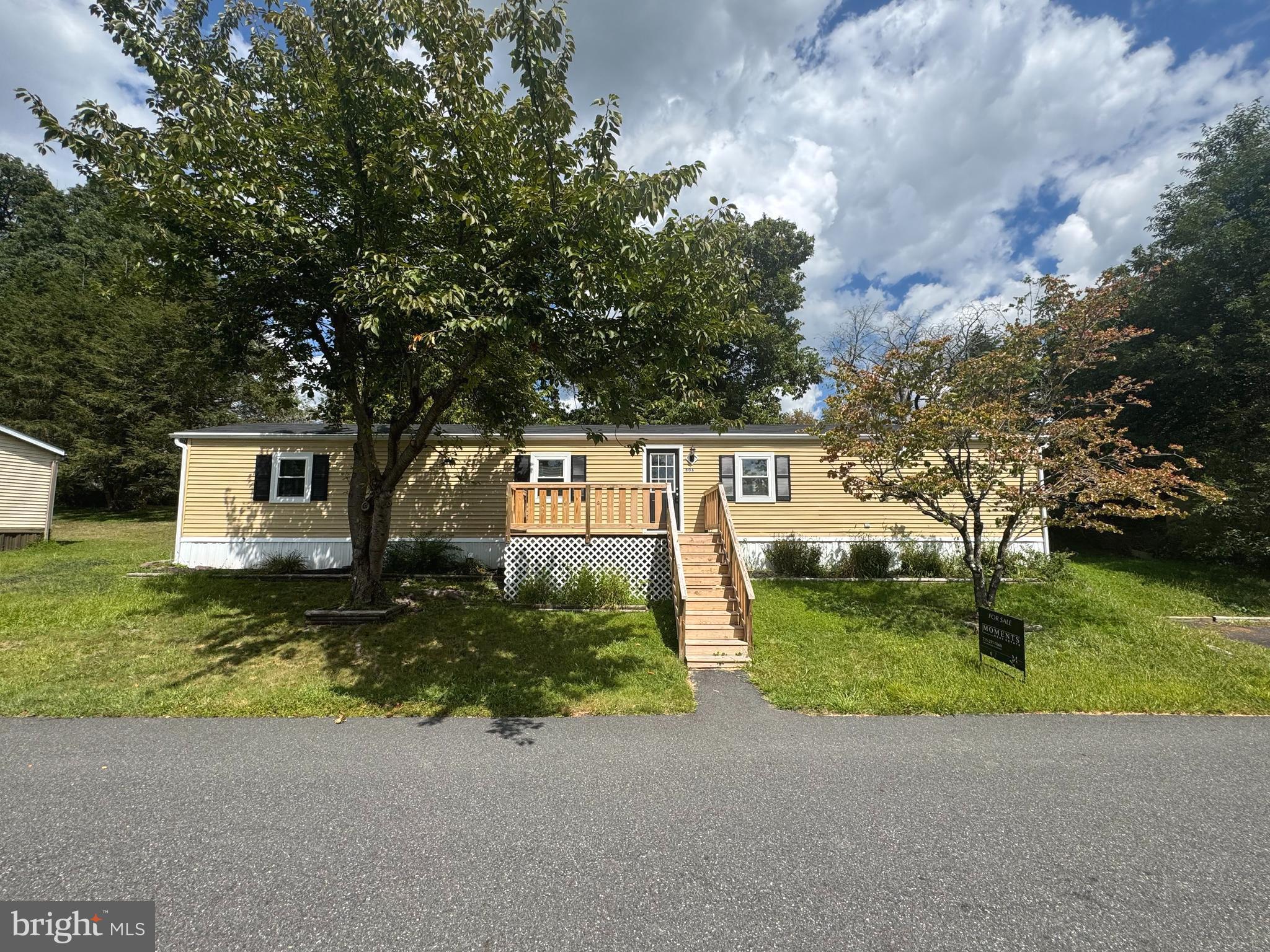 Buying a home in the Green Lane area has always been at the top of my list! Scenic views and various outdoor activities such as walking trails, boating, fishing, skiing all surround my new home thanks to Green Lane Park! As I pull to my driveway, I am first greeted by the lovely deck. I can already imagine sipping my morning coffee, swaying in my rocking chair and taking in all the tree top views. Once inside, the open floor plan welcomes me, as well as, the brand new windows, new floors, fresh coat of paint, and recessed lighting. The living room is cozy and will be perfect for when I host gatherings with my family and friends. I love how the living room flows easily into the kitchen. The kitchen offers white cabinets, tile backsplash, stainless steel appliances, a built-in microwave, sleek hardware, quartz countertops, a spacious peninsula and a sizable pantry. This space is truly a chef's dream! The laundry area is tucked away nicely before I enter my master bedroom. I am so thankful that I do not need to take any trips to the laundromat! Entering my master bedroom, I know I will be able to retreat here after a long day to unwind. The master bedroom offers multiple windows allowing the sunshine to stream through, new carpet, fresh paint, walk-in closet and an ensuite bathroom. The bathroom showcases a stall shower, a rain shower head, modern light fixtures and a double sink vanity offering tons of storage space. On the opposite side of the home is the second bedroom and hall bathroom. I can set up the second bedroom for when my family is staying for extended visits. Or, I might turn it into my home office and craft room. I also love how spacious the bedroom closet is, I will be able to store away so many of my items! The hall bathroom connects from both the second bedroom and living room making it so convenient for guests! The bathroom offers a tub shower, a lovely vanity, modern light fixtures and hardware. As I head outside to the back yard, I am thrilled to have a second deck overlooking the property. The back deck is private and offers shade, which will be perfect for those hot summer evenings. I plan to host many summer BBQs and this space will be perfect for entertaining! Another reason why I like my new home so much is because of the convenient location. Within a 10-minute drive, I have all the stores, shops and restaurants that I need! I have found my own little piece of paradise, and I can't wait to move in!