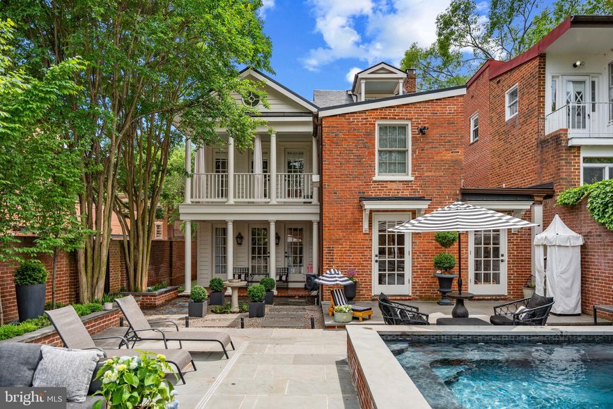 A true masterpiece. Every inch of this home will leave you captivated. One block from the waterfront, this sanctuary blends luxury, modern ease, and sophistication all while honoring its remarkable history. The property sits on land once owned by Richard Arell, a close friend of George Washington. In 1800, trunk maker Ephraim Mills established his workshop here, adding early American craftsmanship to its story. In 1980, it was acquired by famed transportation engineer Alan Voorhees, whose innovations reshaped cities worldwide. The stunning estate has since been converted into a double lot with an expansive addition covering over 5,200 sq ft. of interior/exterior living space. Breathtaking renovations with top-of-the-line designer finishes throughout, this transformed home now features 5 bedrooms, 3.5 bathrooms, 5 fireplaces, on-site parking pad plus additional shared private off street parking in the 30-ft alley, and approved permits for an exterior guest house. 

As you step inside, heated marble floors and a showstopping staircase greet you. The main level presents timeless arched openings, original hardwood floors and fireplaces, a gorgeous dining room, multiple living rooms and lounge areas, and a hand-painted Susan Harter mural connecting the spaces. The powder room features Gucci wallpaper, custom mosaic tile, a custom marble vanity and a gold leaf ceiling. 

The kitchen is designed to be both functional and strikingly beautiful, anchored by an enormous quartz waterfall island. Custom pocket doors conceal premium Miele appliances and storage spaces. Stacked with a 6-burner gas range, double refrigerators, freezer, two dishwashers, wall oven, built-in coffee maker, wine cooler, additional under-island fridge, and lounge with a gas fireplace, this kitchen will undoubtably make your culinary dreams come true. If you are looking for a private outdoor paradise, you’ve found it. This meticulously designed backyard exhibits a resort-style pool (used all year long) framed by sleek fire bowls, multiple lounge areas, a wood burning fireplace, and putting green creating an unforgettable environment for both entertainment and relaxation. 

What you desire in a luxury primary suite, this one delivers. Indulge in the generous layout which features soaring ceilings, oversized windows, an original fireplace, and elegant finishes. The spa-like bathroom offers heated floors, a walk-in steam shower, and double vanity. A focal point of the primary suite is the massive dressing room with its own fireplace and custom-built-ins allowing for effortless organization. Formerly a bedroom, this versatile space offers flexibility depending on your needs. Discover two additional and exquisitely designed bedrooms, with a private balcony and hidden reading nook. A full bathroom with heated floors, a tub/shower combo, and a convenient laundry area complete the third level. When you reach the fourth level, skylights pour in natural light. Exposed wooden beams line the layout to create a charming space. Custom-built-in beds equipped with privacy shades and an adjacent full bathroom make this level an ideal guest quarter. A wrap-around bar, lounge area, and private balcony add to the exceptional ambiance. 

The basement serves as a home gym with a wet bar and mini refrigerator, offering the perfect space to prioritize health and wellness. The recently finished crawl space spans the entire house for all your storage needs. Additional upgrades: stainless steel and slate roof, copper gutters, HVAC system, French drainage system, water heater. Approved guest house plans include a loft, bathroom, and two-car garage. Just steps to the waterfront, King St, bars, restaurants, and boutiques. A short drive to the metro and DC. Don’t miss the opportunity to call this spectacular property home.