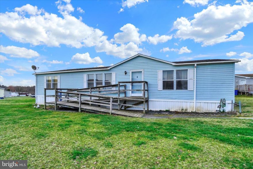 Spacious doublewide in desirable Tall Oak Estates! 1995 Imperial with over 1500 square feet of living space.  Large open Living Room with triple front window for lots of natural light! Vaulted ceilings, ceiling fan & white coat closet/cabinet stays with the home.  The dining room is open to the kitchen with a breakfast bar, gas stove, recessed & track lighting. The laundry room is just off the kitchen with storage cabinets above the washer & dryer, utility sink, access door to primary BR bathroom & an exterior door to the back porch. (washer & dryer are negotiable). The primary bedroom & bathroom are just off the living room.  Nice size walk-in closet & large bathroom with garden tub, walk-in shower stall, double sink vanity & a skylight!  The other 2 bedrooms are on the opposite end of the home, both bedrooms have ceiling fans & walk-in closets (wall to wall carpet will need replaced in bedrooms) The main hall bathroom also has lots of natural light with a skylight! Gradual incline wooden ramp to front entrance of home to make for easy access & backyard shed with electric great for extra storage. Updates include new Roof & new gas furnace in 2016 & new vinyl flooring in 2017!  Nice rural location but minutes to all conveniences! Lot Rent is $631/mo & includes water & sewer!