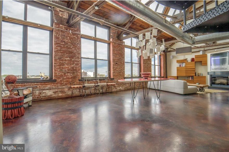 Spectacular renovated NYC style loft with 24' ceilings, exposed bricks, ducts, and beams (both steel & wood). Superb location--with a 97 WalkScore and just blocks from everything Northern Liberties has to offer. Concrete and hardwood floors. One delineated bedroom with walk-in closet and spa master bath plus significant open space for at least 1 more bedroom plus den and office. There is another full bath and a half-bath. This residence offers a perfect aesthetic; huge open flexible loft space, and the practicality to make this loft a home. Open main living floor with big living area and dining area and kitchen. 27' x. 38' of open space with 25 huge windows (some 11' and some 8'). With this much glass, the northern exposure is ideal; one of the brightest homes in the city, but with an even, calming light throughout the day ? perfect for artists or anyone who enjoys abundant and comfortable natural light throughout the day. Meticulously renovated by an artist with both impeccable taste and practical insight. Fine finishes throughout. Gorgeous concrete floors. Entry foyer with double custom coat closet. Open kitchen with honed stone countertops, Miele & Dacor stainless appliances, and the finest cabinetry. A remarkable full tile bath with frameless stall shower. Custom built-in entertainment center/bookshelves/storage cabinets. Quality light fixtures, ceiling fans, and other fixtures throughout. Substantial space for art throughout. The main floor also includes the master suite with more great space and superb light. Huge walk-in custom closet. Stone master bath with air-jet tub and over-sized frameless-glass steam shower with multiple heads. The open 2nd level loft has ceiling heights between 9' and 12' (high ceilings throughout the entire residence) and several open spaces with multiple possibilities. Private half bath and big closet. Hardwood floors. Several large storage closets. 2-zone HVAC. On-site separately deeded GARAGE PARKING. A big space (#P9) that includes a storage shed as well. Amazing loft. Excellent location. Garage Parking.