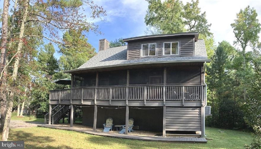 Turn-Key Coastal Retreat with Water Access in Coveted Cove Point Beach

Discover Cedar Beach Lodge—a rare opportunity to own a turn-key retreat in an exclusive beachfront community along the Chesapeake Bay. This stunning 3BR/2BA home is a proven, income-producing vacation rental with a loyal base of repeat guests, or it can serve as your own private coastal getaway.
Just steps from a private sandy beach, the fully furnished home offers effortless comfort and an inviting open-concept design. The great room features soaring ceilings and seamless flow between the family room, dining area, and fully equipped kitchen—ideal for gathering with family and friends. Step onto the spacious deck or relax in the screened-in porch to enjoy morning coffee, evening sunsets, and the soothing rhythm of the waves.
The outdoor amenities elevate the coastal lifestyle even further: enjoy a firepit under the stars, rinse off in the outdoor shower after a beach day, and take advantage of ample parking for guests. A secure walk-in storage area beneath the home provides room for bikes, paddleboards, and all your beach essentials.
From sunrise walks to bonfires at dusk, every day here feels like a vacation. Stroll to the historic Cove Point Lighthouse or hunt for Miocene-era fossils and shark’s teeth along the one-mile private shoreline.
Located just one hour from Annapolis and Washington, D.C., and only minutes from Solomons Island, Cedar Beach Lodge offers the perfect balance of tranquility and convenience. Whether you’re seeking a lifestyle, an investment, or both—this is your chance to own a piece of Chesapeake Bay paradise.