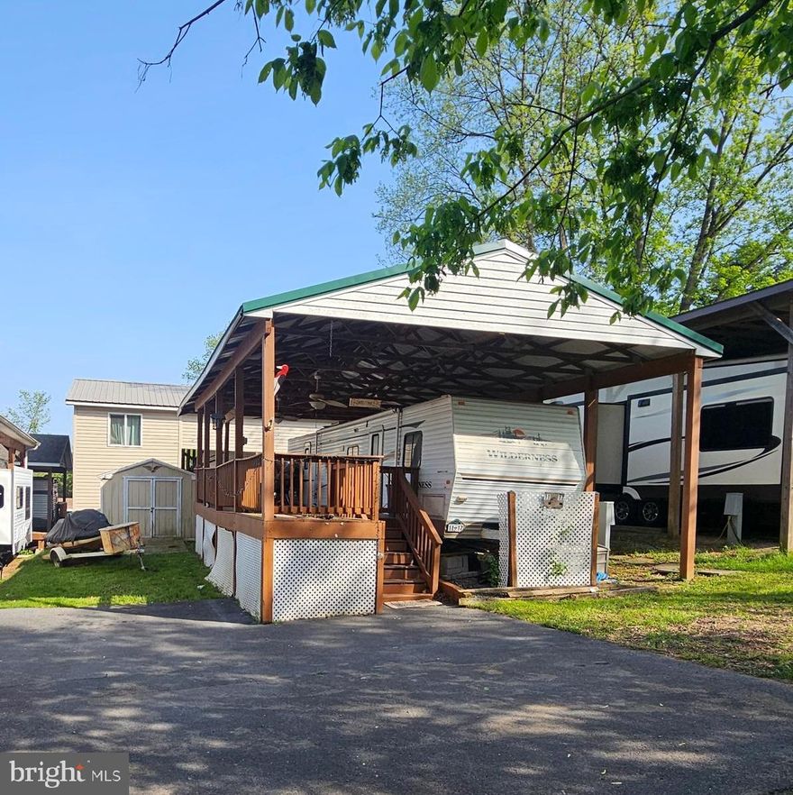 Welcome to Riverbends Block 11 Lot 17 Hot Springs Ave. It is on SEWER not pump out in Riverbends Rv Campground. Riverbend is 400 Acres of SEASONAL recreational campground full of amenities located on the Potomac River in Falling Waters, Wv. OPEN APRIL 1 - NOVEMBER 1 - This is a fun & entertaining community, yet relaxing.
This lot needs a little TLC but not too much to make it your own and the beauty with this pavilion is that you can pull this camper out and put another in if you so desire. Priced to sell. Has paved parking, a side yard and a shed large enough to house a Golf cart. 
  Conveying on this lot is a 2004 Wildwood by Forrest River Camper. It has 2 bedrooms, one on each end of the trailer.  The pavilion also has electric and ceiling fans to keep a breeze a flowing on those hot summer days. In the back is a storage shed and a Golf cart that can convey for an additional $3,000

Approx. 10 miles of Deep water on the Potomac River access for boating, fishing & swimming. Yearly membership ($1,775) plus a $200 initiation fee for new owners, includes water, this one is on sewer, pump outs, electric, trash and the park amenities such as 3 pools, Putt putt course, Horseshoe club, Boat club, Poker runs, Trick or Treat, Christmas in July, live bands, basketball court, tennis court, fireworks, car show, Church, restaurant, bar, convenience store (Great food), playground, volleyball, ball field and much much more. Bring your golf carts, water toys and come enjoy life!