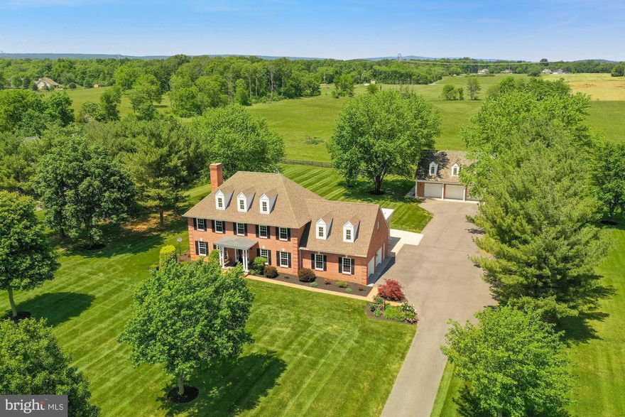 Incredible home, incredible property! Stately, double columned portico with slate front porch. Gorgeous lot & setting with multiple mature trees, beautiful yard & lush landscaping. There’s also a terrific, detached brick garage (in pristine condition) w/3 over-sized bays (43x40) and finished Mother-in-Law suite above. MIL suite is complete w/1 bedroom, 3 closets, 1 full bath, a kitchenette, washer/dryer and comfortable living area (hardwoods, recessed lighting & windows). Detached garage has separate water heater & separate heat pump. This home has been updated throughout-hardwoods on the main & upper level, luxurious moldings, trim work, LED lighting and numerous other details, all with an open layout & amazing feel. All new Pella & Anderson windows, lots of natural light. 100% upgraded kitchen w/Bosch & Samsung stainless steel appliances, large island/breakfast bar w/quartz countertops, induction cooktop w/retractable exhaust vent, shaker style cabinets, crown moulding, built-in microwave, double wall convection oven, custom lighting, wine fridge & a planning desk. Breathtaking sun room off the back (adjacent to the kitchen) w/3 walls of windows. Both the sunroom and family room have glass entry doors to the rear deck. One of the many features of this great home is the 2 car attached carport-perfect for pulling up your vehicles and quick, convenient access to the house. The primary bedroom suite is complete with a remodeled “spa-like” bath with beautiful tile work, enlarged glass door & tile shower w/dual shower systems, double sink vanity, all upgraded light fixtures & mirrors and porcelain tile flooring. Additionally in the primary suite is an expansive walk-in closet/dressing room with built-in shelving and windows. You'll love the expanded home studio (or office) with full bath, windows and recessed lighting…perfect for a variety of uses! Huge lower level w/rec. room, wet bar, recessed lighting, full bath, 5th bedroom, large den and two large storage rooms. Zoned heating & cooling, new Imperium central vacuum system, 80 gallon GE GeoSpring high efficiency heat pump water heater, newer composite decking on rear deck (“Trex” like) and more!