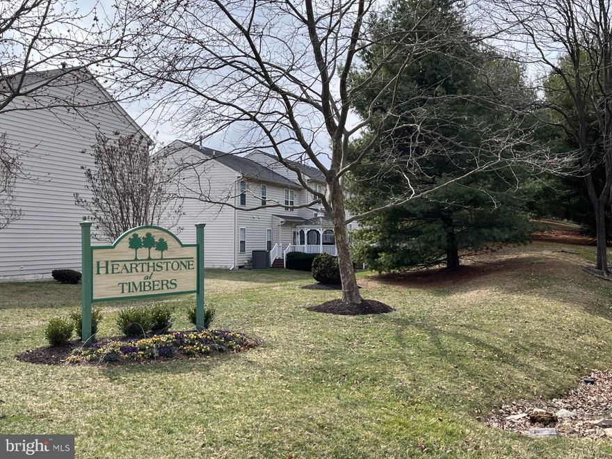 Back on the Market, through no fault of Seller.  Don't miss this incredible opportunity! This highly desirable floor plan is now available in Hearthstone at Timbers, a premier 55+ community in Elkridge, MD. Conveniently located near Rt. 95, it offers easy access to both Baltimore and Washington, D.C.

Step into this charming, sunlit second-floor unit, thoughtfully designed for comfort and convenience. The open-concept layout features a passthrough kitchen that seamlessly connects to the main living area. The kitchen is equipped with Corian countertops, an integrated sink, a pantry, and a laundry closet for ultimate functionality.

Enjoy your morning coffee on the private covered balcony, a perfect spot to relax. The condo is ideally configured with two spacious bedroom suites positioned on opposite ends for maximum privacy. The primary suite includes two closets, an en-suite bath with a walk-in shower, and a dual-sink vanity. The second bedroom suite features its own full bath with a tub/shower combo and linen closet—also accessible from the main living area for guest convenience.

Freshly updated with brand-new carpet throughout, this move-in-ready home also includes a dedicated office with elegant French doors and hardwood floors in the foyer. The building offers a secure lobby entrance with elevator access.

Don’t let this one slip away—schedule your tour today!