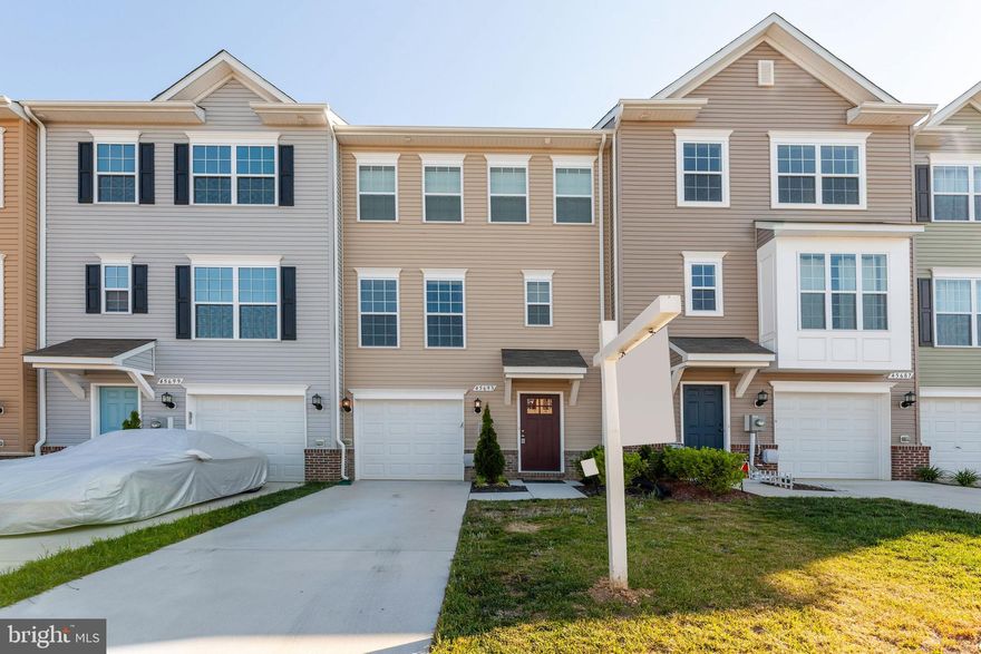 ABSOLUTELY IMMACULATE 3 STORY TOWNHOME IN QUIET ELIZABETH HILLS COMMUNITY 4.9 MILES FROM PAX RIVER! This three story townhome features 3 bedrooms...3.5 baths...open concept living space boasts bright family room...recessed lighting...spacious dining area...crown molding...wainscoting...powder room with hardwood flooring...kitchen with breakfast bar...large island allowing for additional seating and storage...dark granite countertops...stainless steel hardware...lower cabinets with slide out trays...gleaming engineered hardwood flooring throughout ..sliding doors leading to 10' x 12' composite deck with vinyl rails and a sizeable back lot. Top level possesses a stately owner's suite...tray ceiling....full bath with upgraded whirlpool tub with jets, glass shower cage, high rise toilet, upgraded tile, and vanity...2 additional considerably sized bedrooms...full hall bath with upgraded tile and vanity...brand new carpeting in finished rec room/basement...utility closet with freestanding laundry sink...high mounted outlets/HDMI for wall mounted TV's in master and family room...washer/dryer bought brand new and used for less than a year...custom blinds covering all windows...shade cover for sliding door...finished garage...upgraded front door. Although the kitchen does not currently have a complimenting backsplash, the owner has purchased and it's yours for install! Not only is this home less than five miles from PAX River, it's just a short distance away from shops, local markets, and restaurants. THIS HOME IS THE ABSOLUTE CLOSEST TO NEW BUILD YOU CAN GET WITH A RESALE! Run, don't walk! This pristine townhome will be gone in a blink of an eye!