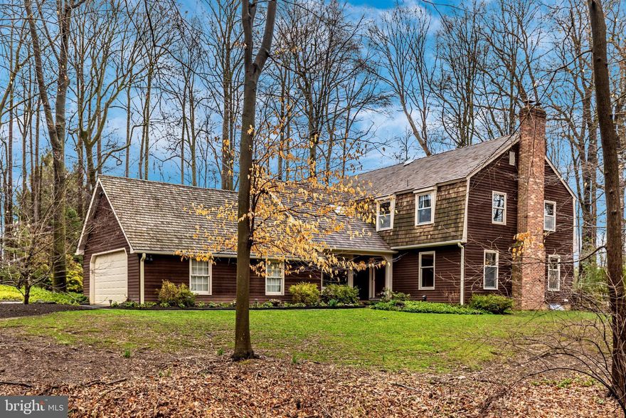 Situated on a private, wooded, 1.75-acre lot is this 4 Bedroom, 3.5 Bath Colonial home. With over 4,000 square feet of living space including finished Basement, the home is located in the heart of Blue Bell, directly across from the nature preserve and walking trails of Prophecy Creek Park. This gracious and comfortable home offers a sensational flow, fantastic entertaining capacity and breathtaking views from every window, including views of the property’s stream. This unique property is well appointed with many upgrades, such as bedroom skylight (2020), most of roof (2019), gutters (2019), water heater (2015), Main Bath (2014), Patio (2013), 2 fireplaces, custom millwork, recessed lighting, Silhouette® blinds, ceiling fans, and laundry chute. Hardwood floors under carpeting in Living Room, Family Room, and Bedrooms. Covered brick Front Porch leads you to the freshly-painted red front door. Welcome to the spacious Foyer with slate floor and double closet. The lustrous Living Room is perfect for entertaining or for an in-home Office and features a fireplace with brick surround and rubbed bronze chandelier. The beautiful sunlit Kitchen showcases rustic-style cabinetry, granite countertops with tumble marble backsplash that feature rubbed bronzed medallions, stainless steel appliances with 2 ovens (one convection), built-in microwave and tile floor. Located off the Kitchen is the resplendent Dining Room—ideal for family gatherings, Homework Room or additional Office. The handsome Family Room offers floor-to-ceiling brick Fireplace with mantel, flanked by built-in shelves, ceiling beams, hardwood floor and sliding glass doors to covered Patio. Laundry Room with included washer and dryer, cabinets, utility sink and access to Patio. Generously sized Powder Room with slate floor. The Main Bedroom Suite boasts a bay window, new Bathroom with double sink vanity, rubbed bronze fixtures, separate commode with tiled stall shower, and 2 walk-in closets. The 2nd Bedroom (currently used as an Office) includes an en-suite Full Bath, skylights, 2 new windows, and access to the massive Attic—which could add possible finished space! Relax in the Full Hall Bath with Jacuzzi and double sink vanity. Two additional spacious Bedrooms complete the second floor. The Finished Basement is ideal for Media, Game, or Fitness Room and includes custom built-ins and Storage Room. Impressive hardscape and landscaping, EP Henry Devonstone Patio (550 square feet), Sandstone covered Patio, 2-car oversized Garage with workshop and cabinets. Easy access to PA Turnpike, Routes 476, 73 and 202, train stations, schools, parks, shops, restaurants, country clubs and downtown historic Ambler with cafes and theaters. This wonderful, secluded home with stream is a nature lover’s dream come true. A true private oasis of tranquility! 1-year warranty included.