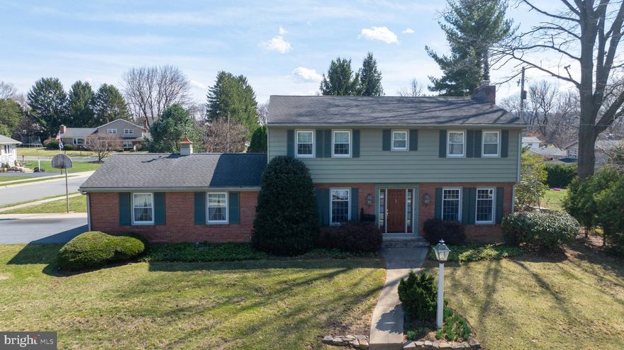 Quality, Wilson 2-Story on Corner Lot       
Boasting the curb appeal of a brick and aluminum siding exterior on a sizable corner lot privatized by a backdrop of mature trees, this fantastic property in Milbeth Village is the perfect place to call home. And with all new, tilt-in windows, pocket doors, new electric, and hardwood flooring under carpeting throughout both levels, the interior only gets better.  
Through the welcoming front entry, the lovely foyer with slate flooring leads to the awesome living room, highlighted by a beautiful brick fireplace with wood mantle and gas insert, tall windows, and sliding glass doors to the large back patio. 
On the other side, you’ll find the elegant dining room, enhanced by chair rail and crown molding and brightened by tall windows. 
The fantastic Richcraft kitchen has everything the family chef needs from solid surface/Corian countertops and tile backsplash to electric cooking, including a built-in range, microwave, dishwasher, and double oven, as well as a large pantry with shelves and maple drawers, and a dutch door to the back patio. 
Also on the main level is a cozy den with oversized windows, chair rail molding, and dark hardwood floors under the carpet, a laundry with porcelain wash bin sink, built-in cabinets, and nearby laundry chute, and a powder room with a new fan. 
The luxurious Master bedroom enjoys an ensuite bathroom with tile floor, step-in shower with glass door, and two large closets, while three additional bedrooms, a big walk-in cedar closet, and a full tile bathroom with a tub/shower and oversized vanity are just down the hall. 
The massive lower level is an entertainer’s dream with an awesome stone wall and stone wood-burning fireplace, wet bar with fridge, bonus room/office for storage or hobbies, a full tile bathroom with tub/shower, and a new slider door to the back patio. 
A two-car, side entry garage offers plenty of storage space thanks to a pull down attic. And outside, you can enjoy the peaceful setting while listening to sounds of a flowing waterfall from your two-tier stone patio with a surrounding stone wall.