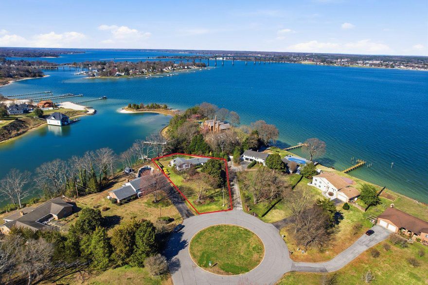 ESPERANZA FARMS. Protected deep-water setting with stunning river views enjoyed since 1972 by these original owner-Sellers. Perched above Lewis Creek, this beautifully maintained 5-bedroom, 3-bath cul-de-sac home offers the ultimate waterfront lifestyle. Enjoy effortless days on the water—sail, cruise by motorboat, or head across the river to Solomons Island for waterfront dining. With direct access to the Patuxent River and Chesapeake Bay, adventure is always just minutes away. When you arrive by land, you'll find a picturesque landscape with established trees and well-tended gardens surrounding this split-level residence, built by Joe Goldsborough.  A specimen 20' diameter Japanese Maple is the centerpiece, and a Japanese Zelkova and a gorgeous magnolia are part of the front yard scape. Inside, solid wood floors flow throughout the main and upper levels. The formal dining room highlights scenic creek views and connects seamlessly to the kitchen, featuring solid wood Amish-built cabinetry, Corian countertops, double wall ovens, a new refrigerator, and space for an island or breakfast table. Moving on, the space between kitchen and garage is a versatile hobby/sewing station and the Seller fondly commented “…a sewing table with a view; who has that?...” This area doubles as a mudroom and laundry area with access to the two-car side-load garage. Upstairs, the primary suite opens to a large composite deck—perfect for morning coffee or evening relaxation. The en-suite bath includes double vanities, a soaking tub, and separate shower. Two additional bedrooms, a full hall bath, and ample storage complete this upper level. The walkout third level offers two additional bedrooms or flexible office/bonus spaces connected by a full bath—ideal for guests or work-from-home needs.  An inviting family room with masonry fireplace and woodburning insert provides the perfect space for entertaining or relaxing on a large sectional…not to mention the cool 1970s faux slate tile floor that is probably the most interesting vintage item here. Connecting the waterfront to the lower living area is a 24 x 13 three-season room (not heat in this room). This is an ideal location to take in the water views and enjoy a sunset cocktail, open the original Andersen sliding windows! The home also includes a fourth level with an unfinished basement ready for a workshop, recreation space, or future expansion. The eighty-foot shoreline includes rip-rap protection and a private dock equipped with electricity, water, and a boat lift. A water depth of about 5 feet accommodates most boats.  Reach the bay quickly, also fish, crab, kayak, SUP and jet ski from your own pier. Additional features include a central vacuum system, in-ground sprinkler system, and Generac generator for added convenience and peace of mind. Ideally located with easy access to shopping and Pax River NAS, this exceptional property is your opportunity to embrace the Chesapeake Bay lifestyle on one of the finest streets in Saint Mary’s County.