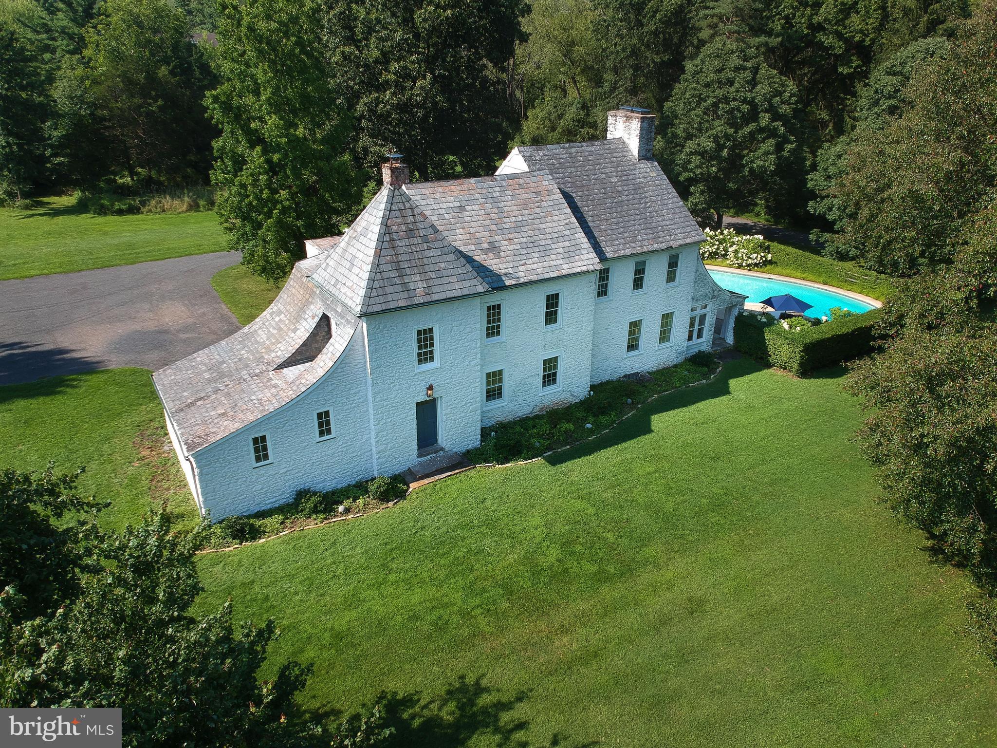 This is a unique opportunity to own one of Bucks County’s most distinctive historic properties. Built in 1780, this 4 bedroom, 3.5 bath French Normandy-style stone farmhouse with slate roof features two wood-burning fireplaces, antique black walnut flooring, a double-height great room with balcony, updated kitchen and so much more. This home sits on 10 acres and boasts a working 12,000 sqft stone bank-barn that is insulated and heated, a refurbished stone spring-house, a tractor barn, grain silo, and a 2,000 sqft accessory dwelling (just waiting to be restored as an in-law suite or guest house). For your further enjoyment of this fabulous property is an in-ground pool, a small pond and a stone-walled vegetable garden for the chef/gardener that likes to grow their own vegetables and flowers. All of this sits far off the road between two undeveloped 10 acre wooded parcels. Located in Doylestown, PA which was voted “Best Small Town Cultural Scene in America” and the home to the Michener Art Museum, the Pearl S. Buck House and the Mercer Museum, this little town attracts an interesting and diverse population. Only 90 minutes from NYC and 45 min from Philly by car (or take the train or bus from the center of town). Top public schools in the state and low taxes makes this a great find. A great property for a home-based business or agriculture related enterprise. The owner currently raises Romney and Lincoln wool-sheep which keep our taxes (and our grass) low and add an old-world feel to the property. Only 10 minutes from one of PA’s best agricultural schools (DelVal University). Make your appointment today to see this private and intriguing home. Interior pics to come.