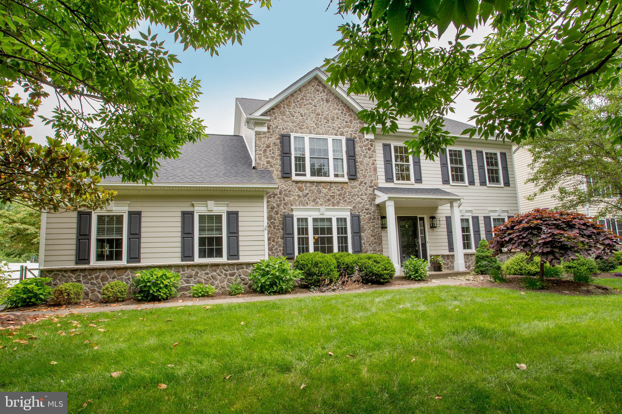 Wow, wow, wow! In the highly sought-after Ridings of Buckingham, this meticulously maintained and superbly updated property is filled with exceptional high-end products, materials, and finishes. The renovations were done by skilled craftsmen in collaboration with an interior designer. It is a luxury home in every way and there is virtually nothing to do but move in and enjoy its gracious and comfortable ambiance. New roof, newer HVAC system, sump pump, gas water heater, expanded patio with inside remote control awning, landscaping, and a fully fenced rear yard that backs to open space. Best of all, the exterior is Hardie Plank and stone, taxes are low and it has public water and sewer. The beautifully proportioned living room and dining room provide a wonderful flow into the eat-in kitchen and family room. The chef’s kitchen is a showstopper! High-end custom made cabinetry, exquisite highest level granite countertops (you’ve never seen one like this), Thermador 5-burner cooktop with pot filler above it, double Bosch wall ovens and refrigerator, lighted, seeded glass front display cabinets, a transom, and an entertainment center with bar sink and wine refrigerator. The casual dining area has a sliding door to the patio and with the knee walls removed, the family room was redone with hand scraped Hickory wood floors and a hand hewn mantel from an old beam was added above the fireplace. Completing the main floor is a beautiful powder room, an office and a laundry room with access to the 2-car garage. Upstairs is the primary bedroom suite that has incorporated one of the three other bedrooms into its footprint. It can remain that way and be used as a closet, sitting room, nursery or it can again become a bedroom. The two full bathrooms are both stunning in design and have exceptional granite. All the light fixtures throughout the house were carefully curated. At this home, the outside is as special as the inside. It offers comfort in sun and shade on a large paver patio that has an enormous remote control awning. It is a serene and private area in which to relax and entertain. Enjoy all the landscaping including the Southern Magnolia tree beside the driveway. Central Bucks School District, close proximity to the dining, shopping, museums, movie theater, specialty stores, parks and train station in Doylestown Borough and in Bucks County. The location is accessible to commuting routes to Princeton, Philadelphia, and NYC. Welcome home to your own slice of perfection.