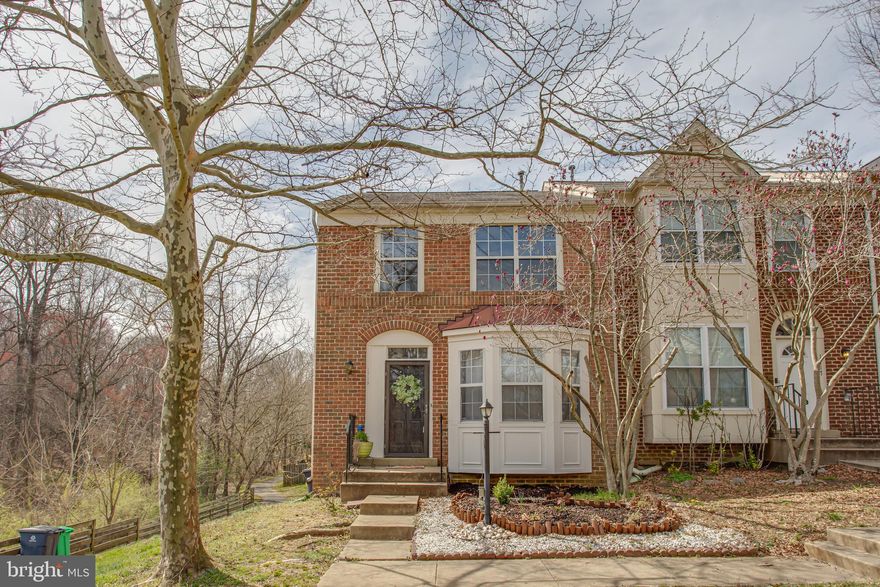 Fantastic 3 level end unit townhome with brick front and brick side. Extra windows for tons of natural lighting. Nice open floor plan with 9' ceilings, hardwood floors, crown molding and bay window in Living room and Dining area. Designer chandelier and custom mirror wall in Dining area. Spacious island kitchen with unique slate flooring, stainless steel appliances, LED lighting, plus sliding glass door leading to a large deck overlooking the fenced backyard. Guest half bath also on the main level. Upper level features beautiful owners suite bedroom with dramatic vaulted ceiling, box bay window and walk-in closet. Owners suite bathroom also has a vaulted ceiling, tile surround soaking tub. Two additional guest bedrooms and updated hall bathroom. Fully finished walkout basement has a  cozy fireplace with slate surround and wood mantle in  recreation room, additional remodeled full bath, laundry area and sliding glass door leading to backyard. Updated HVAC system. Updated modern light fixtures, plus a whole lot more. Simply a must see.