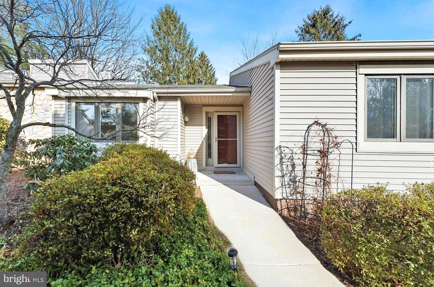 Welcome to this impeccably maintained Thornbury unit in the sought-after Franklin Village within the Hershey’s Mill Community! From the moment you step inside, you’ll be greeted by warm hardwood floors that flow through the main living areas, setting the stage for a home that’s both stylish and inviting. To your left, discover a modern kitchen designed for both function and charm. It features a sunny window banquette, a cozy breakfast area, an island perfect for prepping, stainless steel appliances, wood cabinetry, new quartz countertops, and durable laminate flooring. Adjacent is a formal dining room—ideal for hosting dinners—opening onto a serene screened-in porch. Here, you’ll be surrounded by lush, mature landscaping and the peaceful sights and sounds of a bird lover’s paradise. The living room is a true showstopper, bathed in natural light and anchored by a wood-burning fireplace. It’s a welcoming space for entertaining or simply relaxing with loved ones. Down the hallway, you’ll find a well-placed full bathroom, a convenient laundry room, and a linen closet. The second bedroom, which easily fits 2 twin beds is perfect for guests or a home office. The main suite is your personal retreat, featuring an oversized bedroom with a cozy reading nook (banquette), a walk-in closet, two additional closets, a vanity with a second sink, and a generously sized bathroom complete with a walk-in shower. Downstairs, the expansive basement offers endless possibilities, with a den area, workshop, storage space, and even a utility sink. A detached one-car garage and ample additional parking complete this home. Franklin Village residents enjoy their own large saltwater community pool, perfect for swimming or lounging. Hershey’s Mill enhances the lifestyle with low-maintenance living, covering exterior upkeep, lawn care, trash/recycling, snow removal, water/sewer, cable, and internet—all within a gated community offering 24/7 security. The amenities are unparalleled: an 18-hole golf course with optional golf and social memberships, over 35 active clubs, a sports complex with a heated pool, tennis, pickleball, platform tennis, bocce, shuffleboard, and more. There’s even a community workshop, library, and center for added convenience. Don’t miss the chance to join this vibrant, resort-style community and enjoy the best of low-maintenance living!