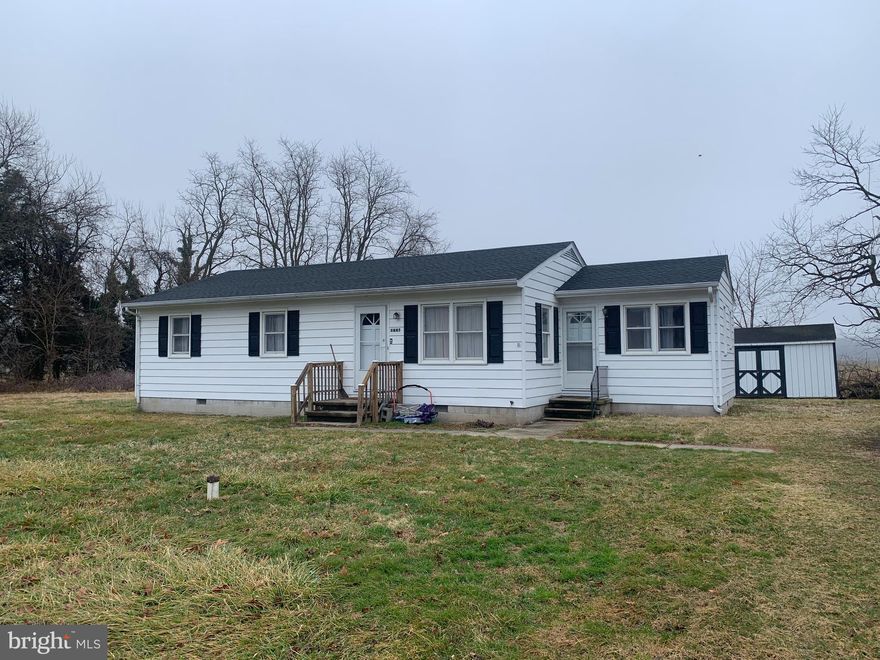 Lovely 4 Bedroom home with 1 and 1/2 baths located just outside of town.  This home has 2 separate entrances at the front of the house.  One can be entered and separated from the whole house living space.  Great for an office with 1/2 bath or used as another bedroom if you need 4.   Kitchen leads to separate laundry and mud room  and exits to the back yard with a view of acres of  open space fields.