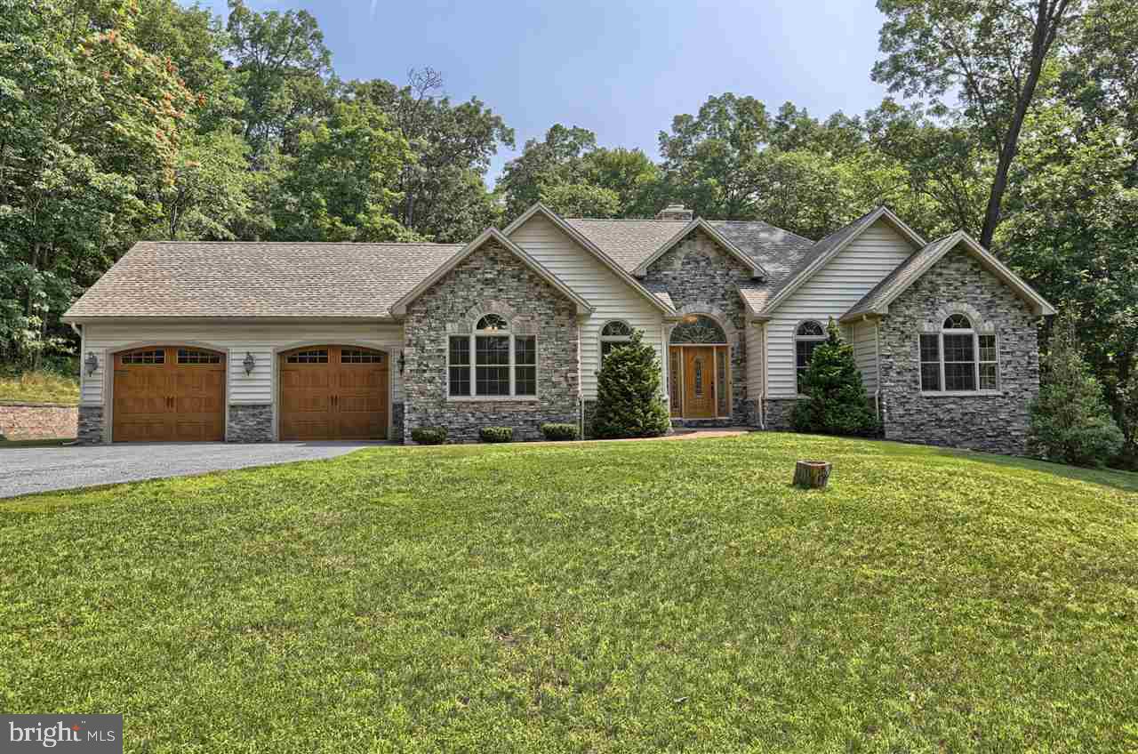 This gorgeous ranch sits on a large wooded lot at the end of a quiet cul-de-sac. From the moment you enter the driveway, you will know this meticulously maintained home is something very special! Open foyer leads directly into the spacious living room w/see through wood burning fireplace & raised mountain stone hearth running the whole way up to the cathedral ceiling & hand hewn beams. Large gourmet kitchen w/huge open area has endless possibilities & can be used as a FR or large DR for larger gatherings.