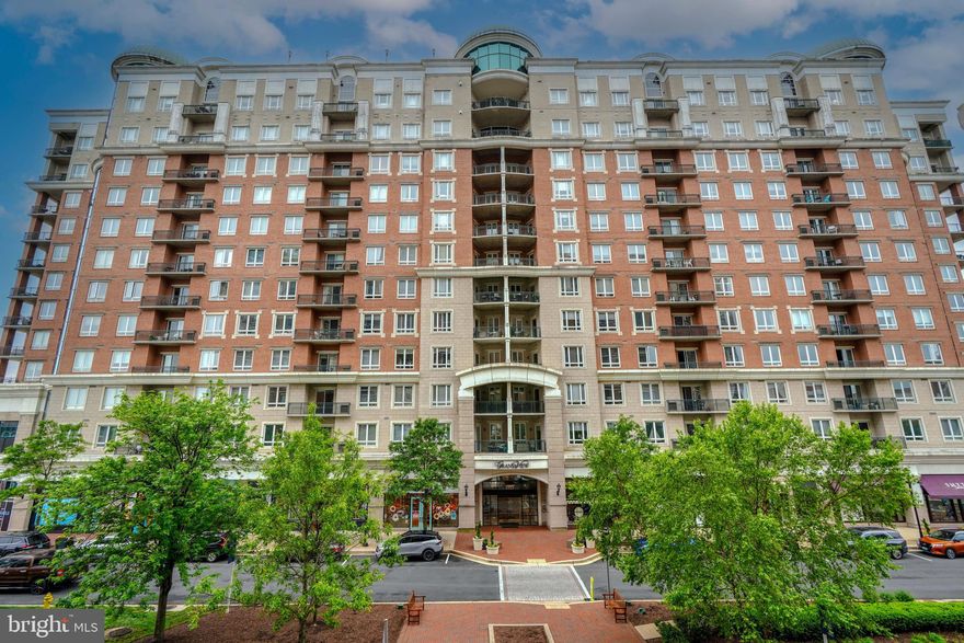 Welcome home to luxury living at its finest, where every detail has been meticulously crafted to elevate your lifestyle to new heights, with amenities including concierge services, rooftop pool and sundeck offering a serene panorama of the city skyline, fitness center, social club, covered parking with passkey security, and more!   Nestled in the heart of Annapolis Towne Center, your residence is surrounded by charming boutiques to designer storefronts and array of restaurants, cafes, and bistros, along with a haven of rejuvenation services.  Weekends and after the sun sets, Annapolis Towne Center becomes alive with events and entertainment.  Stepping off the elevator on the 6th floor and into your private unit, you’ll find loads of natural light, with north-facing views overlooking the tree lined sidewalks, with park benches and manicured gardens alongside the backdrop of buildings.  Featured in the living room and dining room are trey ceilings with intricately designed crown moldings.  The gourmet kitchen boasts deep rich cabinetry and granite countertops, and the current owners are graciously installing a suite of high-end Bosch black stainless appliances.  A pair of French doors lead to a cozy, yet functional den with ample space for a desk, bookshelves, and comfortable seating.  Trey ceilings extend into the owner’s suite featuring two closets, including a walk-in, and en-suite a spa-like bath with air bubble corner tub, two sink granite vanity, and shower with semi-frameless doors and body spray panel.  The secondary bedroom also features an en-suite full bath with neutral tone tiles, two sinks and shower.  There's covered parking in attached parking garage with 2 assigned parking spaces, elevator access to the unit.  Conveniently located just off Rts. 50 and 97, and just minutes from Westfield Mall and downtown Annapolis!