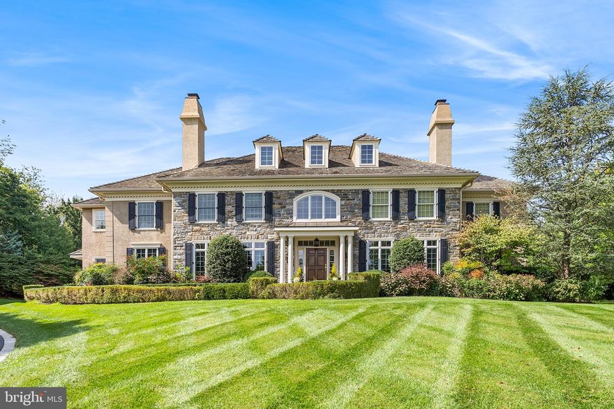 **All Offers due by Saturday September 29th at 6:00 PM.**Stately, impeccably maintained stone colonial perched on a sweeping one-acre lot in Berwyn’s prestigious Saybrook neighborhood! From a sidewalk-lined loop, a Belgian-block edged driveway leads to a professionally landscaped slate front path. Inside, a soaring foyer and grand entry staircase create a stunning first impression, along with abundant custom millwork, upgraded lighting, fresh paint, a Sonos® whole-home audio system and Brazilian cherry floors. Just off the entryway sits a sun-drenched living room with deep-silled floor-to-ceiling windows and a gas fireplace. From there, an oversize arched opening leads to a two-story open family room with a stone accent wall, gas fireplace and expansive window wall overlooking the lush backyard. Just beyond you’ll find a fully equipped chef’s kitchen with six-burner Wolf® range, oversize island with sink, double wall oven and butler’s pantry with wine fridge. The kitchen spills into bright and sunny breakfast room ideal for casual family meals. Just steps away sits a mudroom with custom cubby storage, a rear powder room and direct access to the three-car garage. Tucked away on the other side of the main level you’ll discover his and her offices, one of which could also function as a sunroom or playroom. A front dining room with custom moldings and a second (formal) powder room complete this immaculate first floor. Upstairs, a juliet balcony separates the primary suite from the secondary bedrooms, creating two distinct wings. In addition to a spacious bedroom with tray ceiling, the primary suite boasts a large sitting room and walk-in closet with custom wood shelving. The spa-like ensuite bath features nearly every amenity imaginable, including a jetted tub, shower with frameless glass door, water closet, double sink vanity with marble countertops and abundant cabinetry. On the other wing of the second floor, you’ll find a large laundry room and four well-sized secondary bedrooms—two with ensuite full baths and two that share a jack-and-jill bath—plus stairway access to a large (unfinished) attic for extra storage. Back downstairs, an open staircase leads to the finished basement, which the current owners lowered to create ten-foot ceilings. This level features multiple areas for easy entertaining and play, including a full bar with dishwasher and sink, a built-in saltwater fish tank, a temperature-controlled wine cellar and a full bath. French doors open to a short set of stairs that lead the rear greenspace. There you’ll discover an oasis of calm and beauty, from the bluestone patio to the sprawling flat yard bordered by mature trees and plantings.  Other highlights of this amenity filled home include a fully automated front house landscaping lighting, lawn irrigation,  garage TEK cabinets & wall organization system,  a partial house generator, interior & exterior cameras and a new HVAC system. Zoned for award-winning T/E schools and just minutes from downtown Berwyn and Paoli, this delightful home is waiting for you to tour. Clean stucco report available.