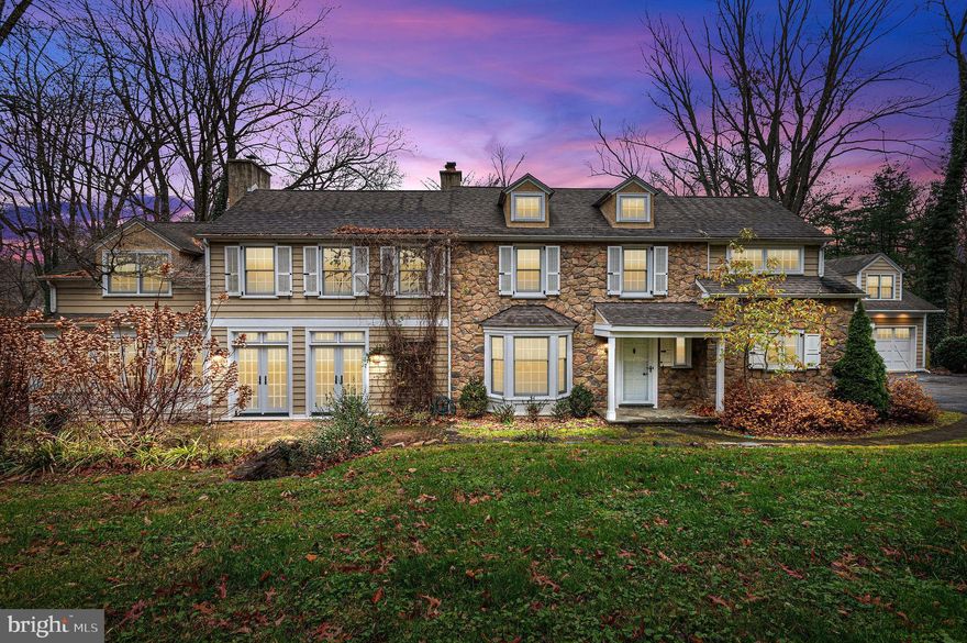 A must see, this stunning Main Line stone Colonial is the home of your dreams! Beautifully appointed, this home boasts a classic farmhouse style with modern amenities, an open floor plan while still maintaining historic charm.  Nestled on a private 2 acres, this home will meet your every need inside and out!  The landscaping has been meticulous maintained and even includes a picturesque creek running through the rear of the property.  As you enter this beautiful home, you will notice the gorgeous hardwood flooring that is carried throughout the house, along with wainscoting, crown molding, and recessed lighting that evidences the great attention to detail that has been given to every space.  The large entryway and mudroom branch off into an illuminated pantry and beautifully milled half bathroom.  Perfect for entertaining in size and layout, the sun-drenched, spacious gourmet kitchen is any cook's dream!  Custom cabinetry with subway tile and granite counter tops for days as well as an expensive center island and large breakfast area provide all the space you need for serving a crowd!  Or celebrate in the massive formal dining room with a beautifully detailed wood-burning fireplace and stunning double French doors.  Then retire to the large living room with a second wood-burning fireplace and sunny bow window.  The gorgeous hardwood floors and millwork continue to shine here as well.  The cozy family room includes full length window seating and tons of naturally light from windows on both sides of the room. An absolutely gorgeous, chandeliered staircase leads to the second floor with a bright open landing, 4 generous bedrooms, 3 full bathrooms, and an enclosed laundry area.  While the hardwood floors continue through the second floor, the bathrooms offer the ultimate comfort with radiant floor heating!  All bedrooms have illuminated closets that activate with the opening of the doors. The owner's suite has spacious his and hers walk-in closets with custom organizers, and a showcase ensuite bathroom with his and hers granite top sink vanities, makeup vanity, and large soaking tub in it's own naturally lit nook. French doors and wall sconce lighting complete the high end look of this stunning bathroom!  The remaining bedrooms continue the beautiful hardwood flooring, spacious closets, and generous natural light. Two hall baths have gorgeous tiling, and heated (radiant) flooring.  This home also includes a detached garage with a finished second floor - perfect for an office, studio, or just extra living space as it is heated and air conditioned! Lastly the main house has a large attic for tons of storage!  And it should be noted that this home has 4-zone heating powered by a high efficiency heating system.